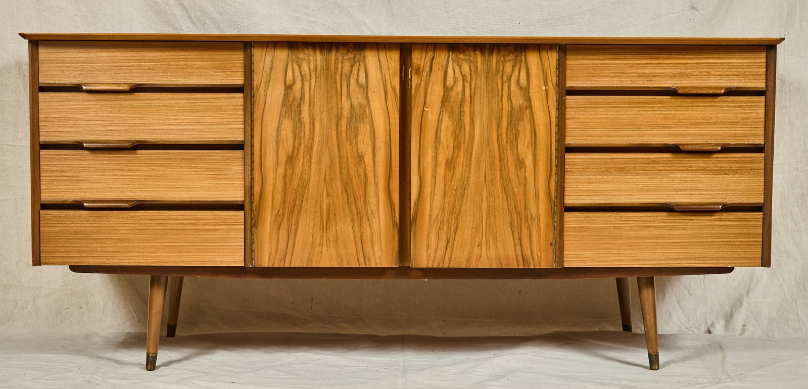 MID-CENTURY MODERN CREDENZA with EXOTIC HARDWOODS: Drawers and cabinet appointed with a variety of hardwoods. The upper left drawer divided. unmarked 30 1/2 x 68 x 19 1/2 inches