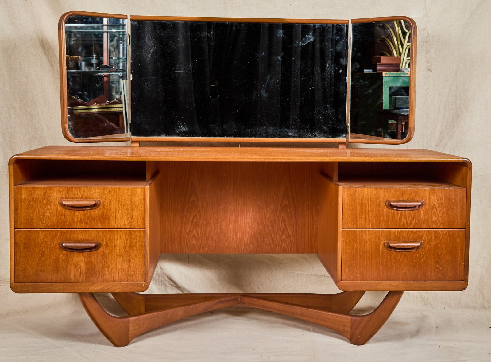 BEITHCRAFT MID-CENTURY TEAK VANITY: Triptych vanity mirror, (2) semi-floating banks of drawers, signature sculpted "X" base. 46 1/2 x 60 x 18 inches.