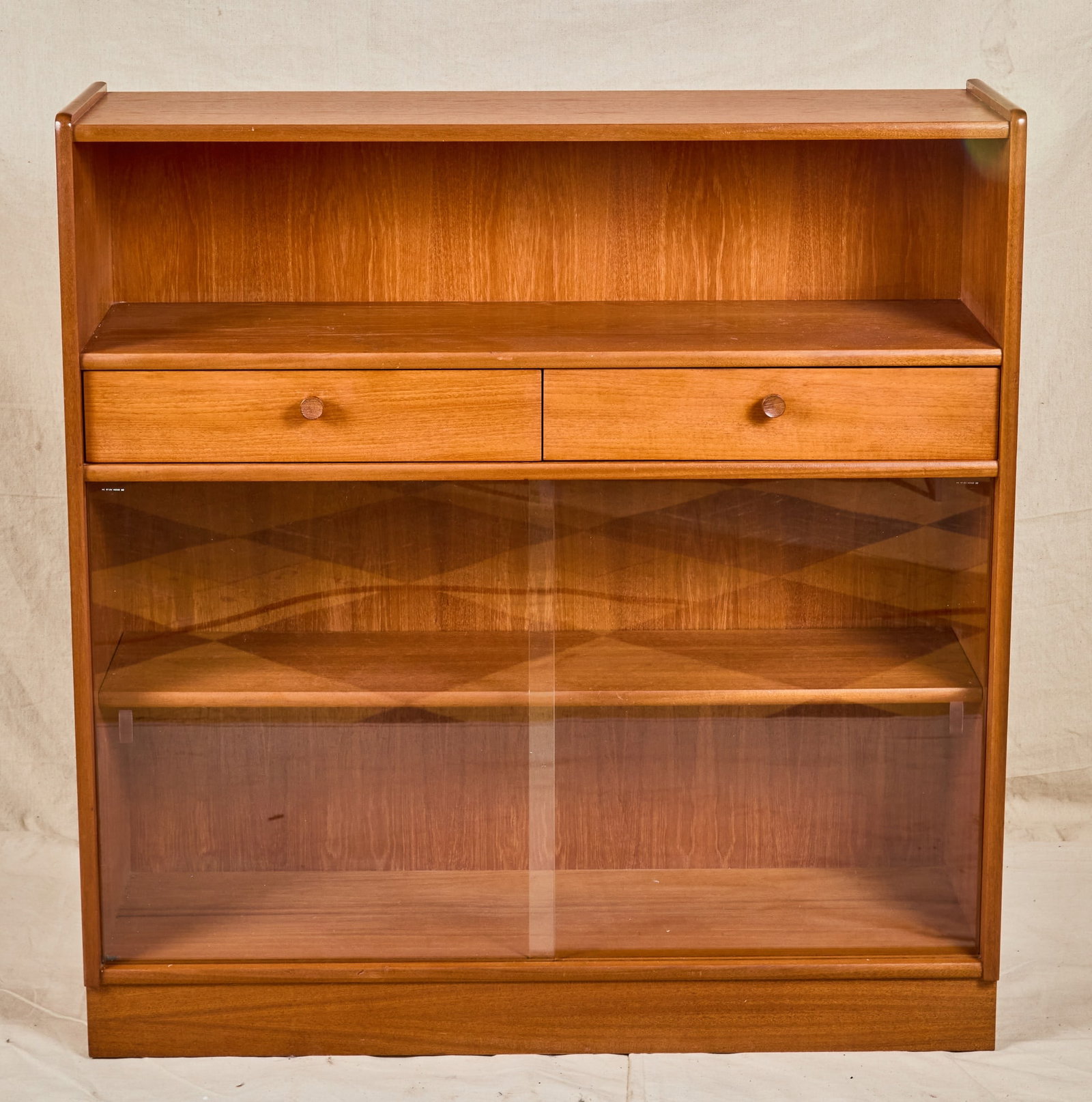 NATHAN OAK CABINET with SLIDING GLASS DOORS: Upper shelf above (2) drawers with lower shelving enclosed by sliding glass doors. 42 x 40 1/4 x 12 1/2 inches.