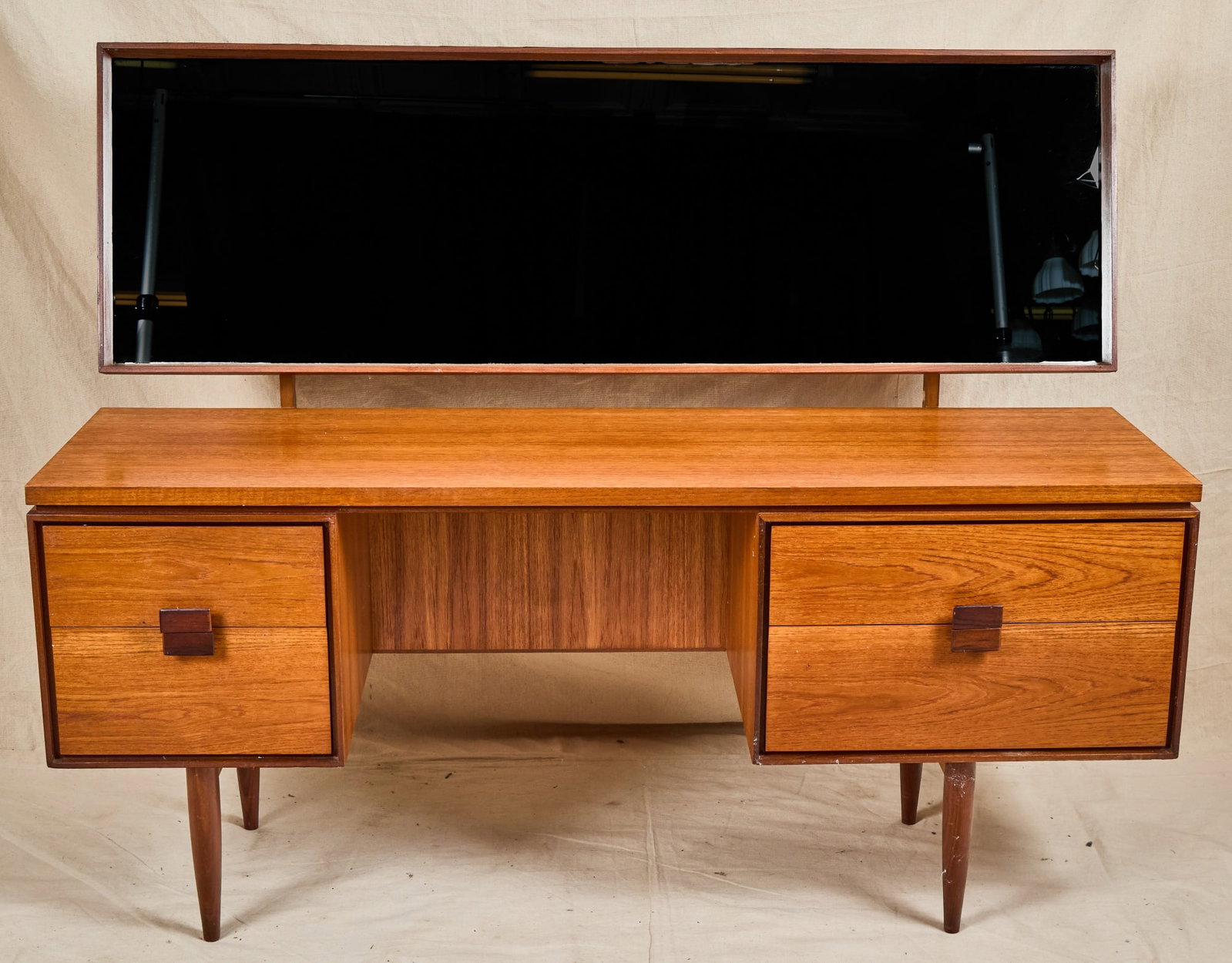 IBK LARSEN for G PLAN DANISH RANGE DRESSING TABLE: I.B. Kofod Larsen for G Plan teak "Danish Design" mid century dressing table with articulating mirror and asymmetrical banks of drawers with mirrored pulls. 48 1/2 x 62 x 19 inches.