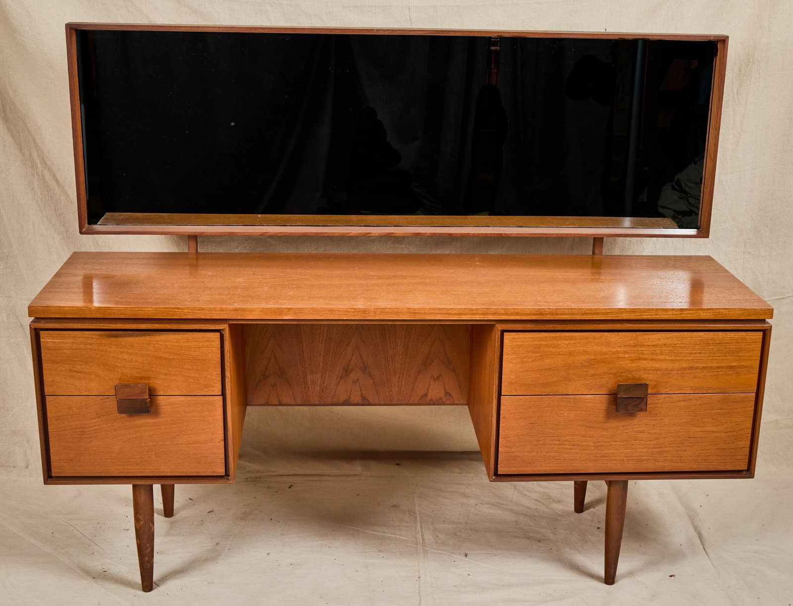 IBK LARSEN for G PLAN DANISH RANGE DRESSING TABLE: I.B. Kofod Larsen for G Plan teak "Danish Design" mid century dressing table with articulating mirror and asymmetrical banks of drawers with mirrored pulls. 48 1/2 x 62 x 19 inches.