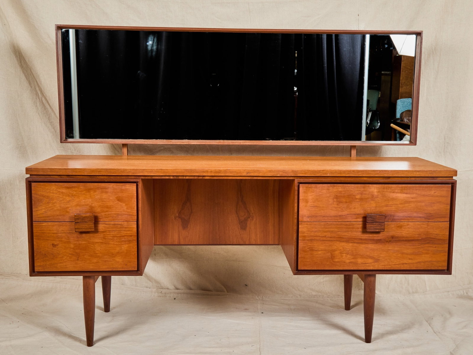 IBK LARSEN for G PLAN DANISH RANGE DRESSING TABLE: I.B. Kofod Larsen for G Plan teak "Danish Design" mid century dressing table with articulating mirror and asymmetrical banks of drawers with mirrored pulls. 48 1/2 x 62 x 19 inches.