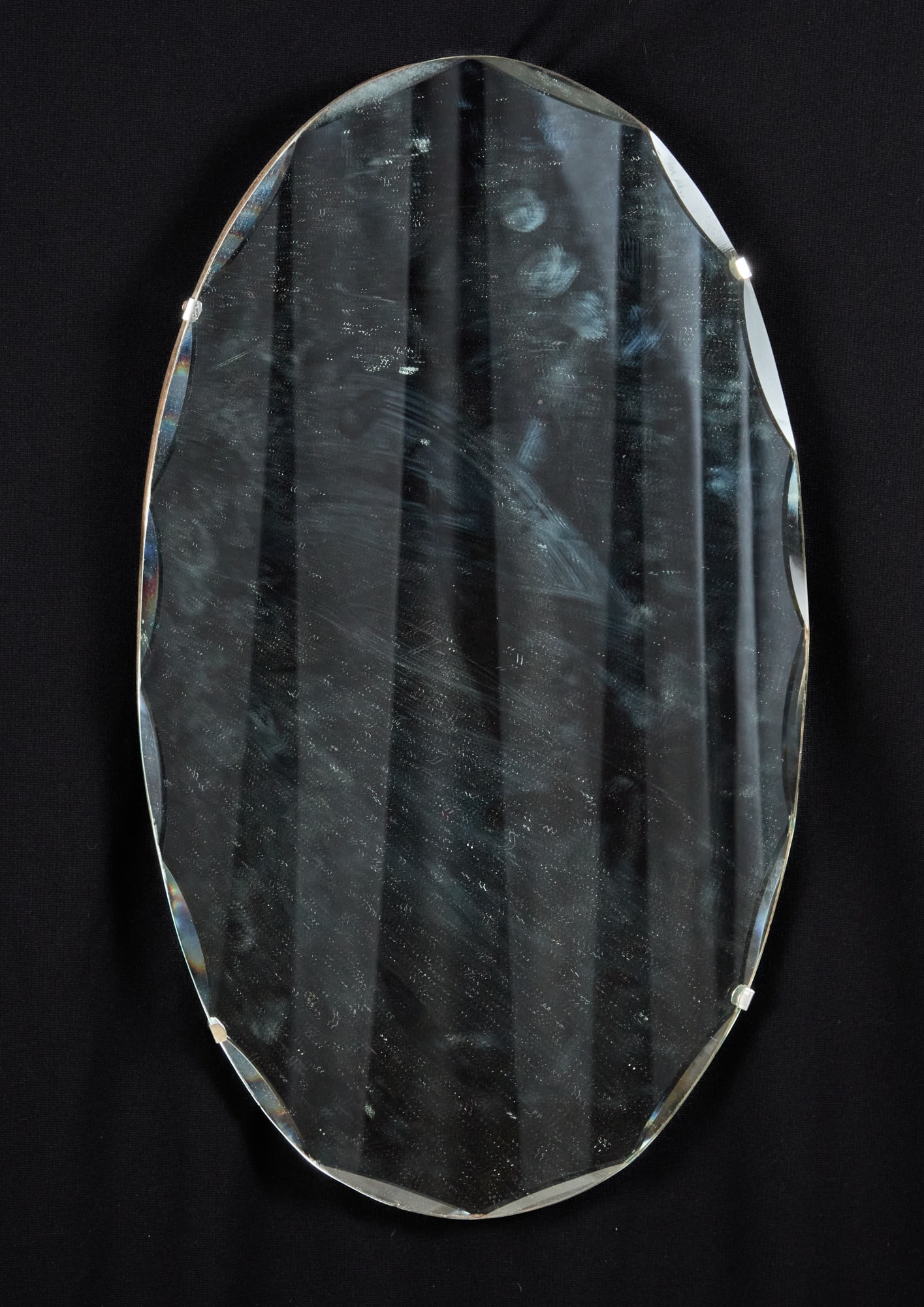 ART DECO SCALLOPED BEVELED-GLASS FRAMELESS MIRROR: Beveled glass mirror mounted on laminated board with chain for hanging. 21 3/4 x 13 inches.