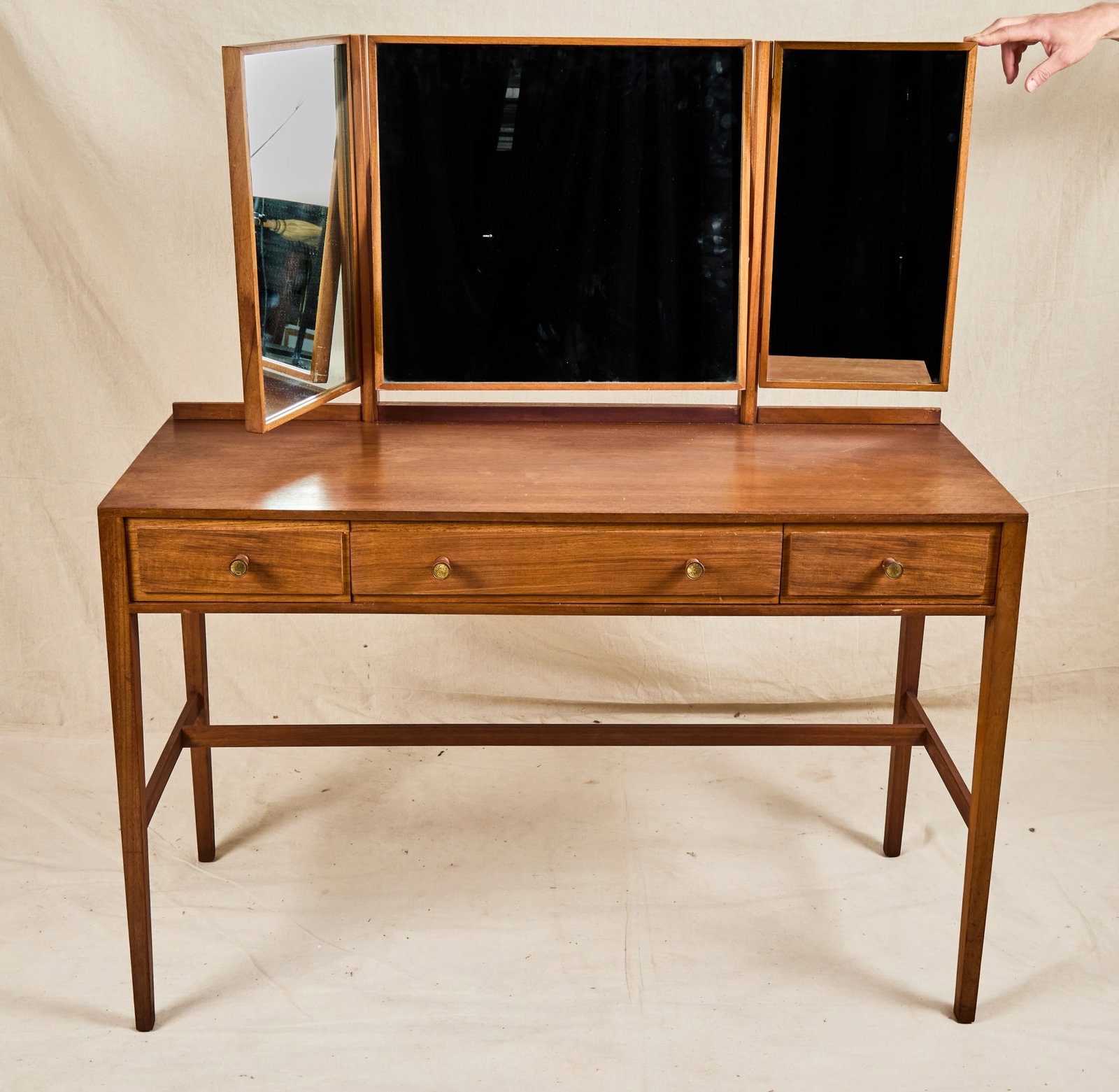 LOUGHBOROUGH MID-CENTURY WALNUT VANITY: With triptych mirror. 51 1/2 x 46 x 20 inches.