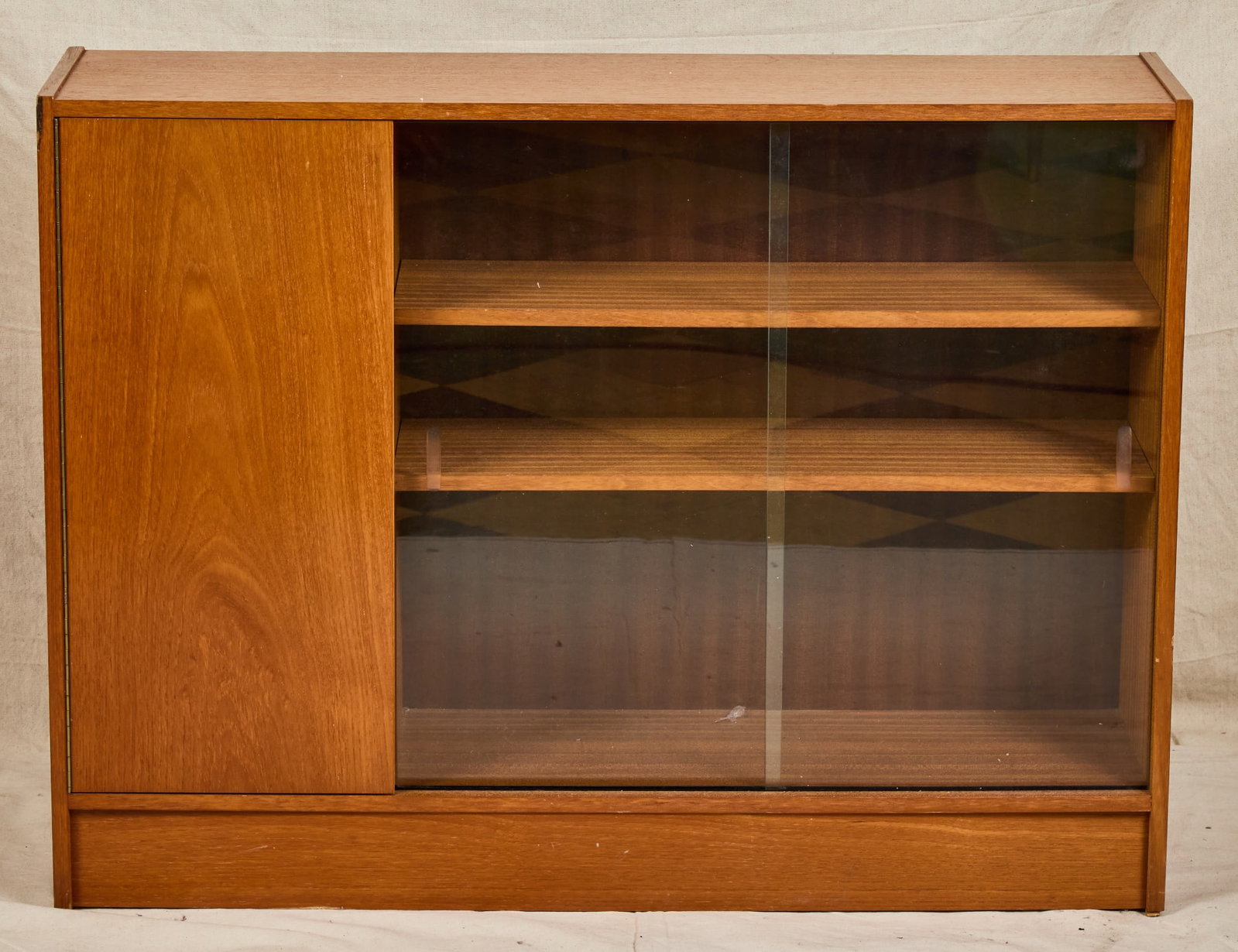 MID-CENTURY TEAK & OAK CABINET with SLIDING GLASS: Mid century teak & oak cabinet with sliding glass doors. 31 x 41 1/2 x 11 inches.
