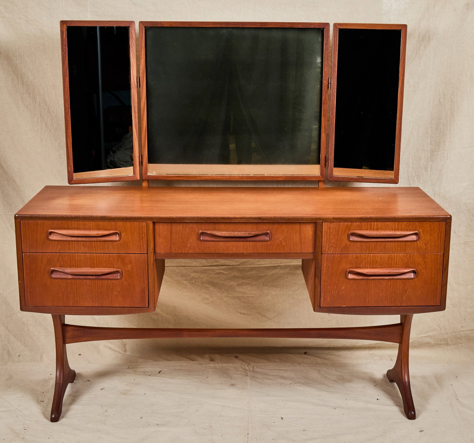 G PLAN MID-CENTURY "FRESCO" VANITY: Triptych mirror, raised on wishbone stretcher base. 52 x 54 x 18 inches.