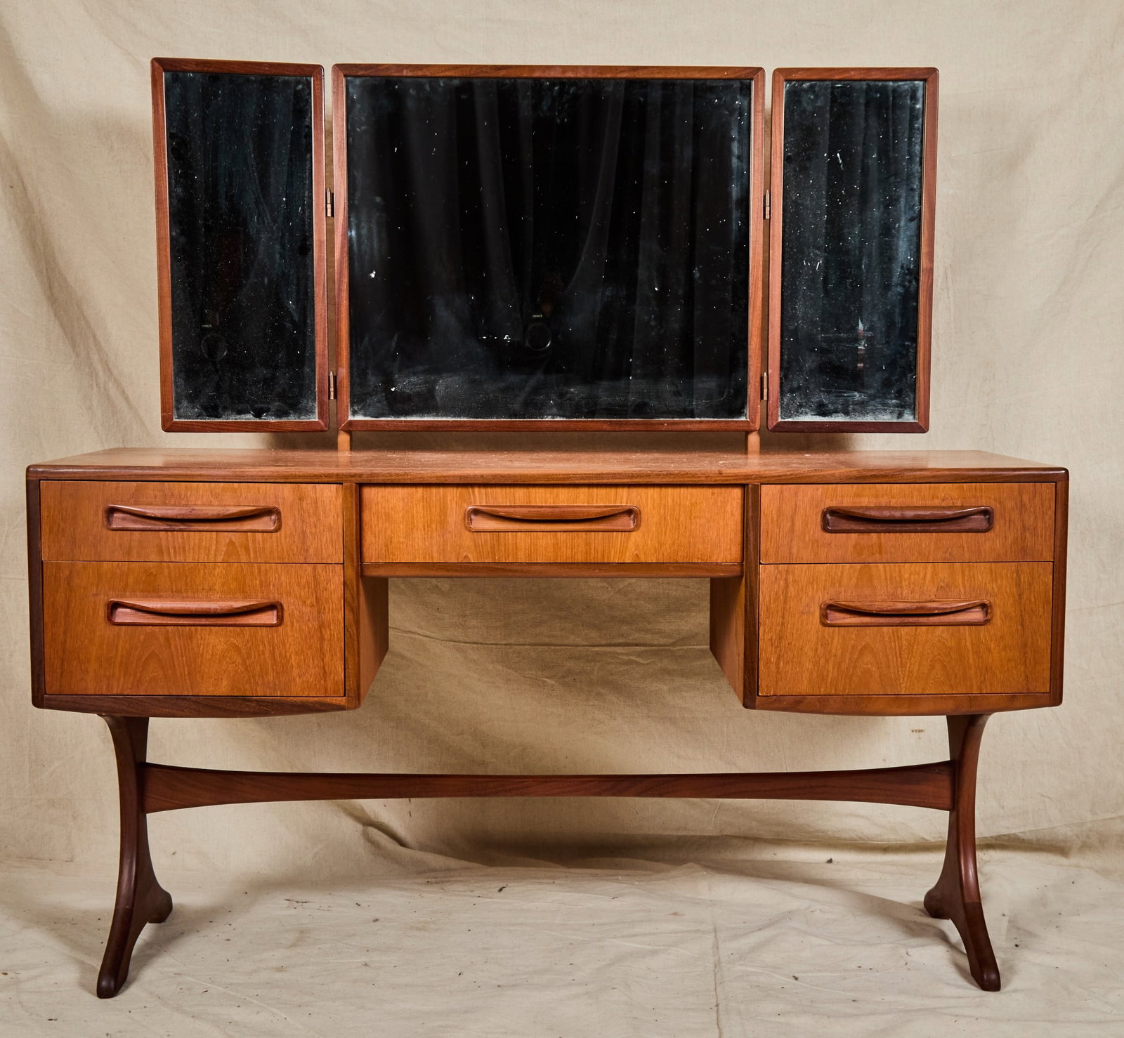 G PLAN MID-CENTURY "FRESCO" VANITY: Triptych mirror, wishbone stretcher base. Labelled inside drawer. 51 1/2 x 54 x 18 inches.