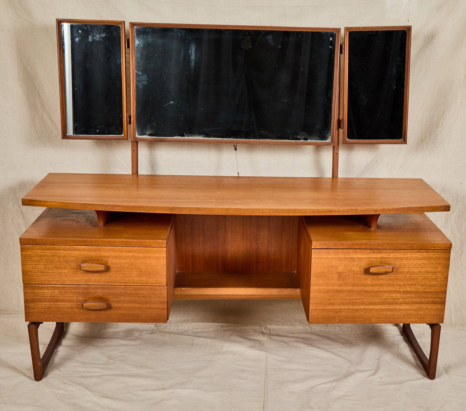G PLAN MID-CENTURY DESK with FLOATING TOP: Repurposed as a vanity with triptych mirror. Gilt label inside drawer. 50 1/2 x 60 x 18 inches.