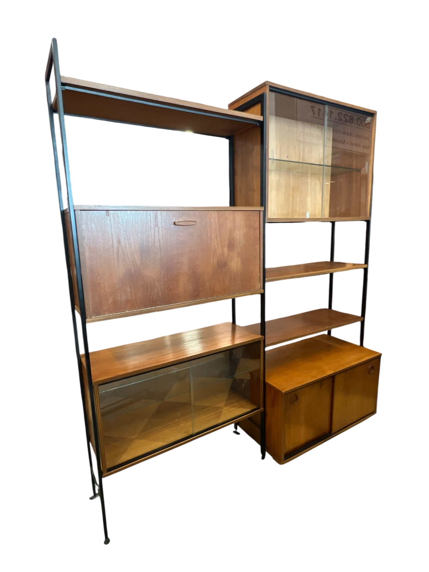 AVALON MID-CENTURY MODULAR SHELF UNIT: Cabinets and shelving rest on steel cross members supported on a steel frame. 73 1/4 x 66 x 12 inches.