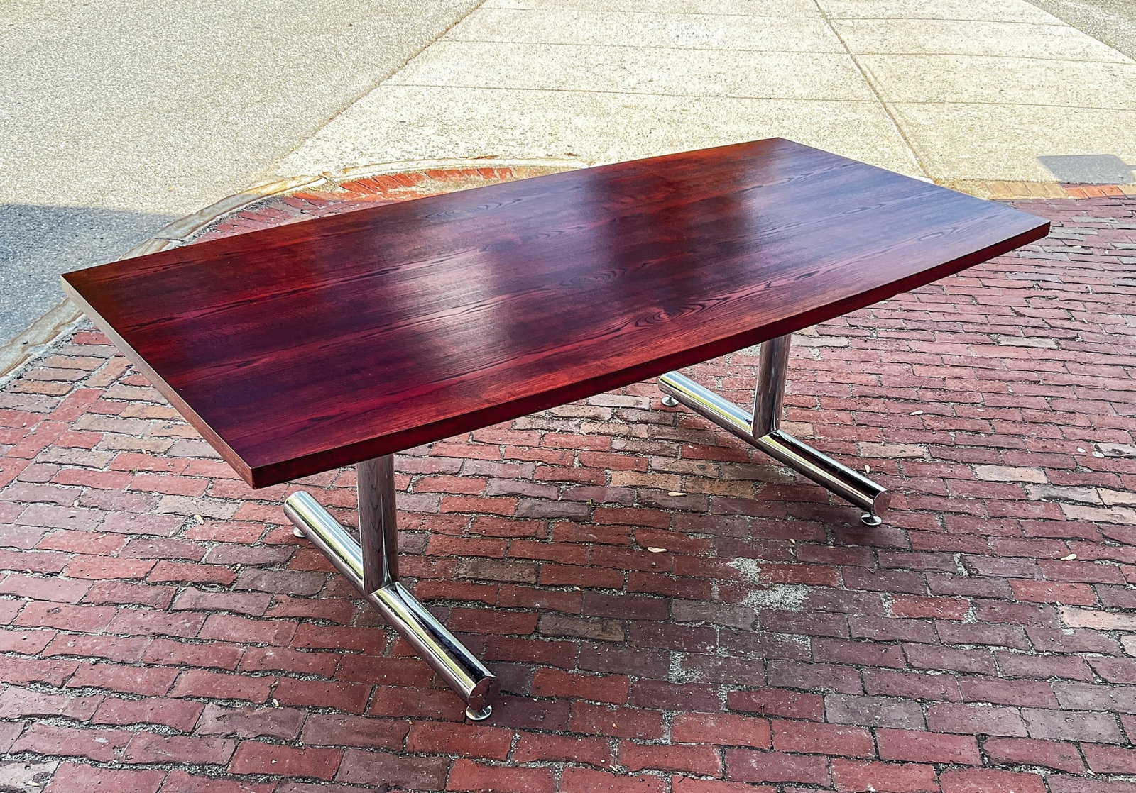 TIM BATES for PIEFF MID-CENTURY DINING TABLE: Boat shaped walnut top on chrome base. Labeled under top. 29 1/4 x 39 1/2 x 78 3/4 inches.