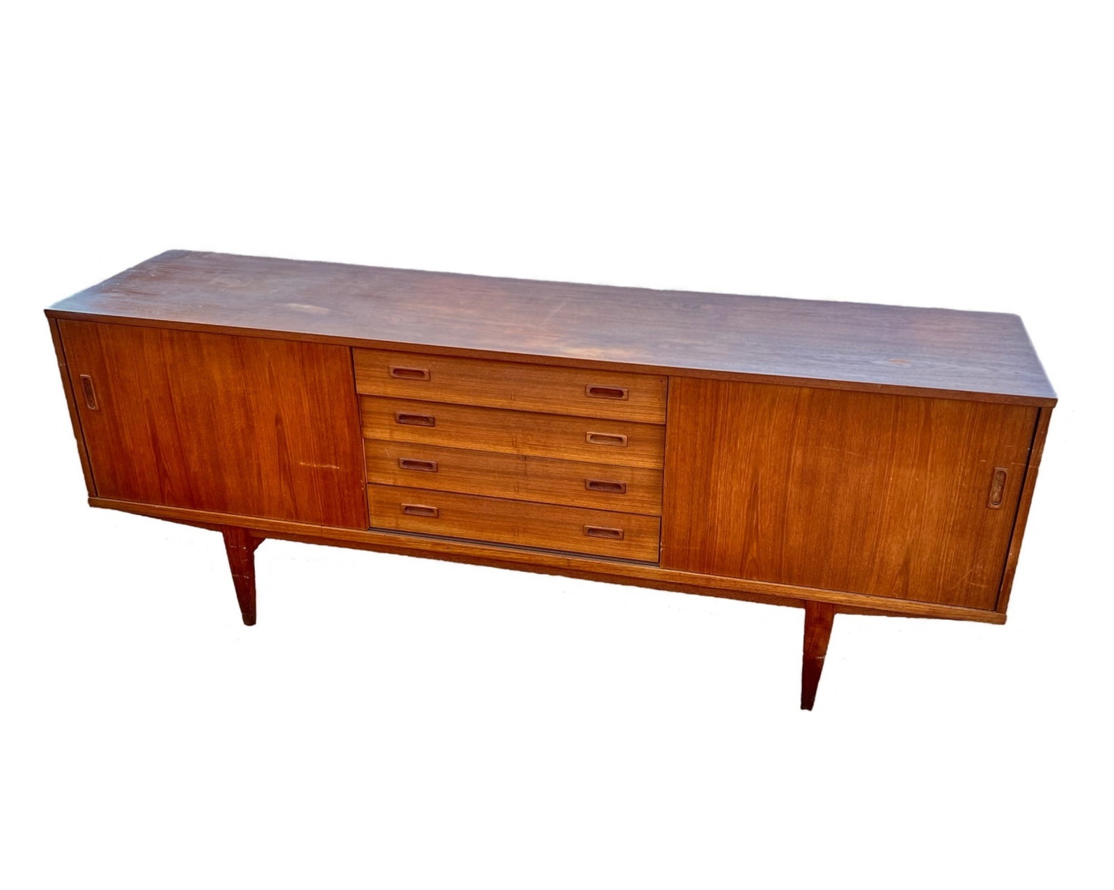 LYBY MOBLER DANISH MID CENTURY MODERN CREDENZA: (2) sliding doors open to adjustable shelving with (4) center drawers, of which one is felt lined with a removable tray. 31 3/4" x 82 1/4" x 19 3/4"