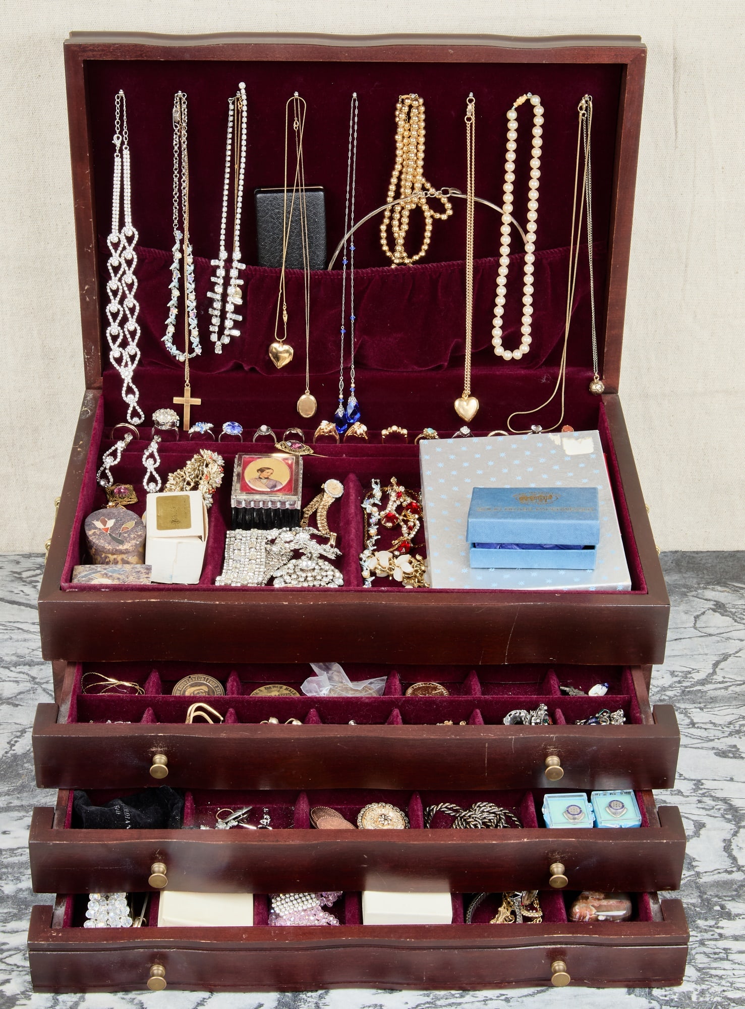 WOODEN LIFT TOP JEWELRY BOX: With (3) drawers and contents of costume jewelry. 9 1/2 x 18 x 12 1/2 inches.