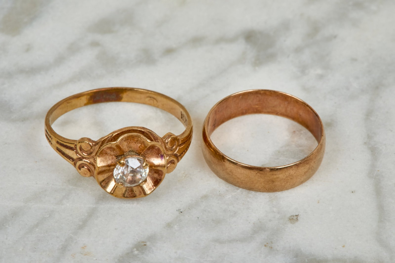 (2) 10K YELLOW GOLD CHILDRENS RINGS: (1) with stone. Size 0 and 3. 1.1 dwt gross weight.