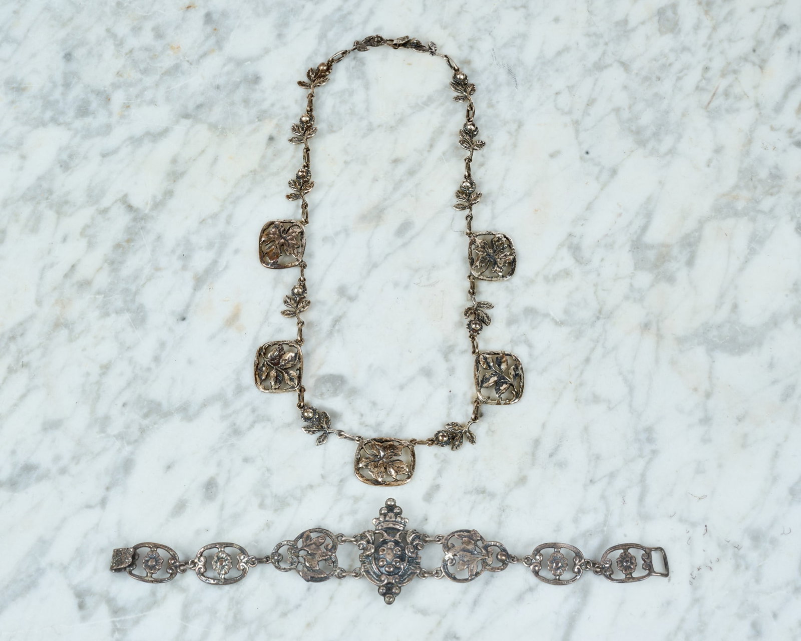 FIGURAL STERLING BRACELET & SMALL NECKLACE: Bracelet with central armorial crest & floral links marked sterling, small necklace with floral links tests silver. Necklace 14 1/2 inches. 1.31 ozt.