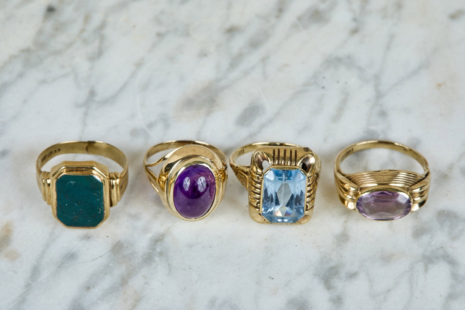 (4) 8K YELLOW GOLD RINGS: With green Onyx stones, blue, and (2) amethyst. sizes (2) 9, 7 1/4, and 8. 8.4 dwt.
