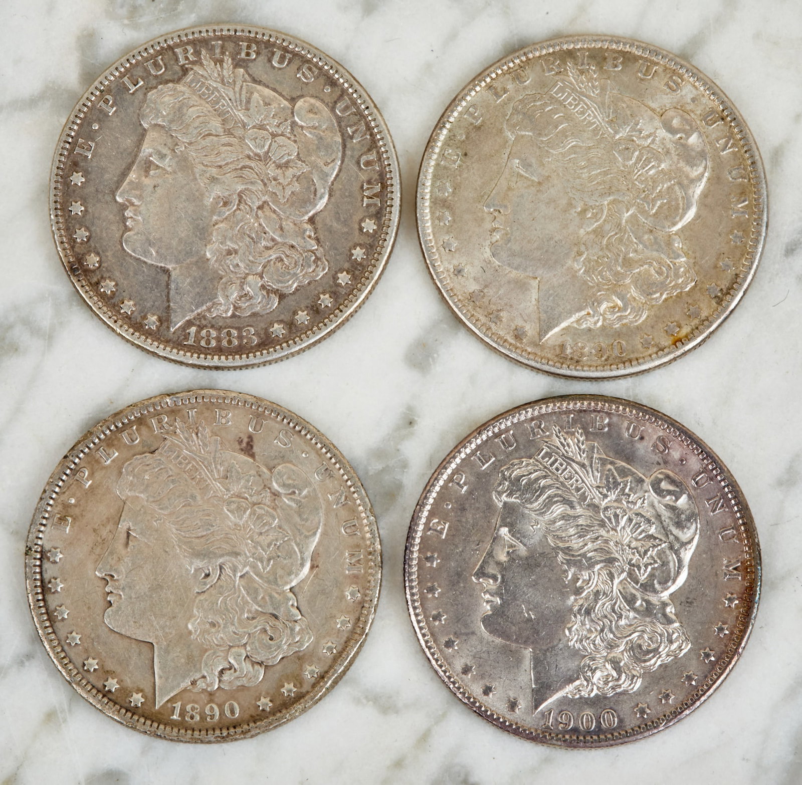 (4) MORGAN US SILVER DOLLARS: 1883, 1890, 1890S and 1900. 1 1/2 inches.