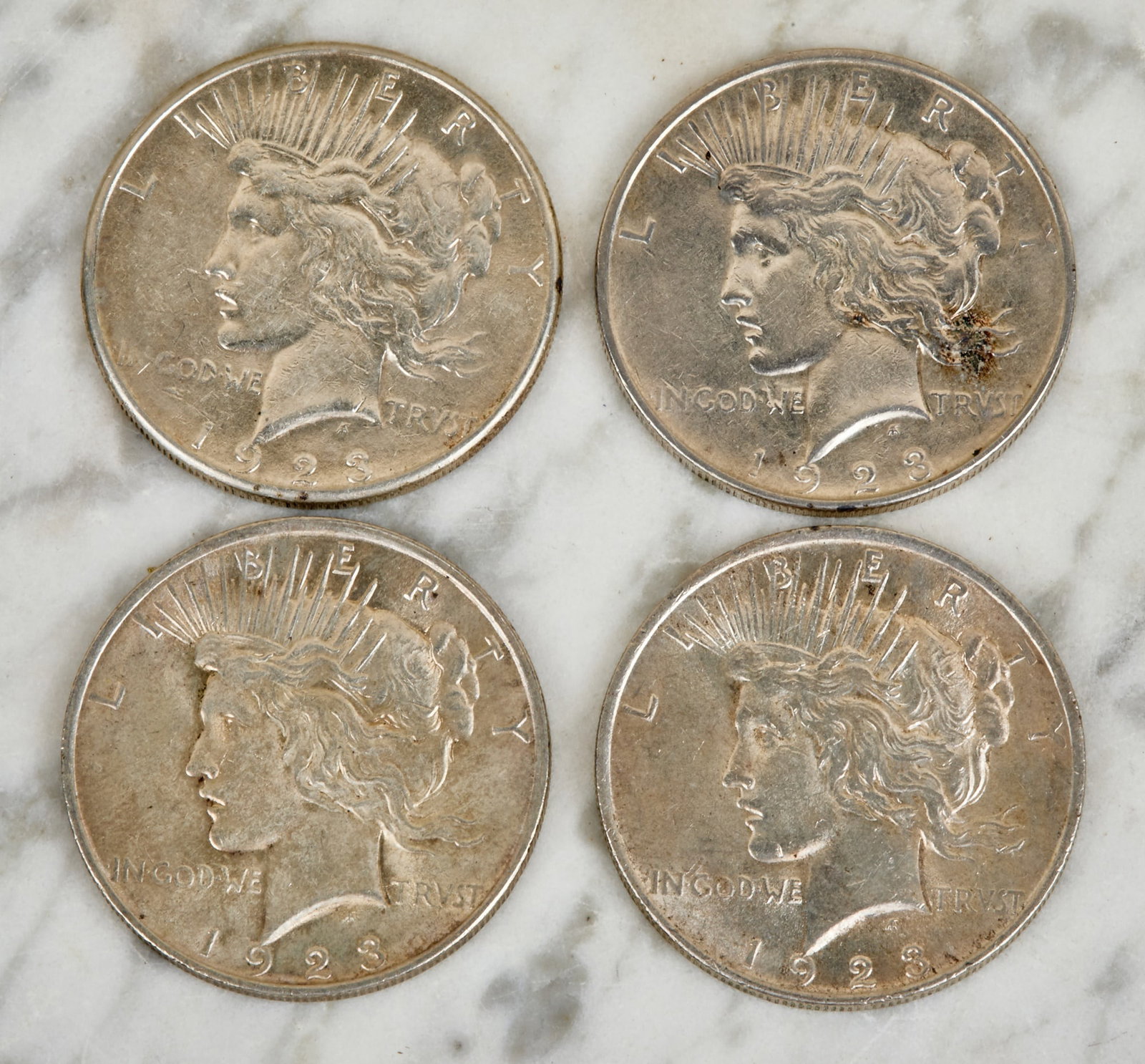 (4) 1923 US PEACE SILVER DOLLARS: (1) with D and (1) S mint marks. 1 1/2 inches.