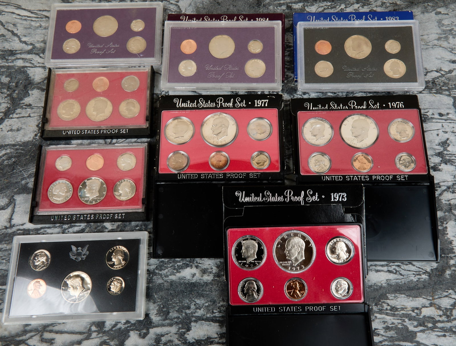 (9) US PROOF SETS: 1972, 1973, 1976, 1977, 1980, 1981, 1983, 1984 and 1985. 4 x 6 inches.
