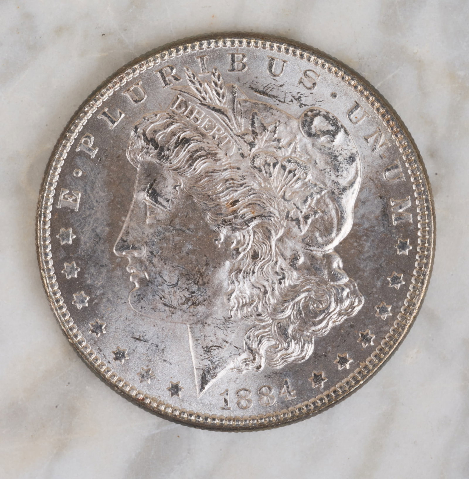 1884 MORGAN US SILVER DOLLAR: High grade.