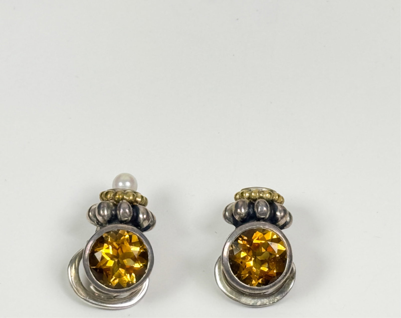 PAIR LAGOS CAVIAR 14K GOLD & STERLING EARRINGS: Pair clip on earring with 11 mm citrine. 1 1/8 inches. 21.57 gross weight.