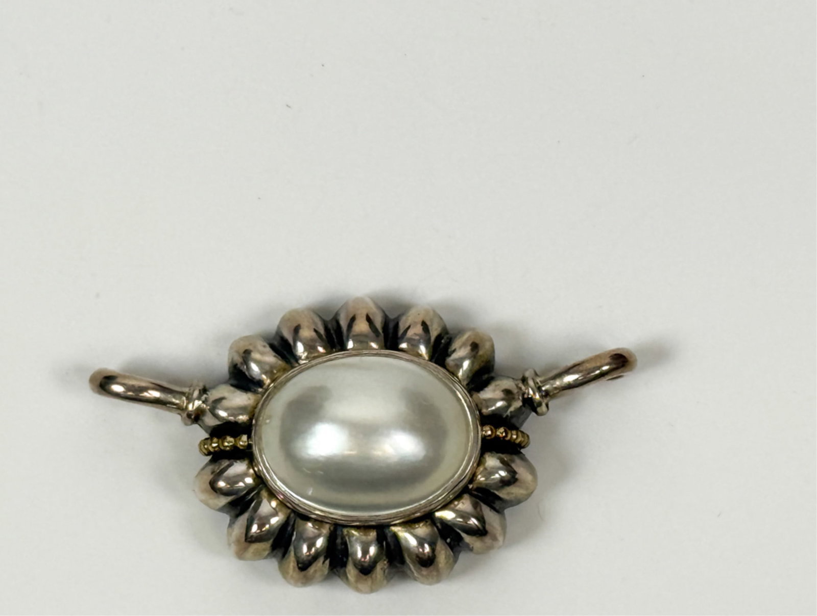 LAGOS CAVIAR 14K GOLD & SILVER PENDANT: With large 19 x 15 mm Cabochon pearl. 2 inches. Gross weight 17.26 grams.