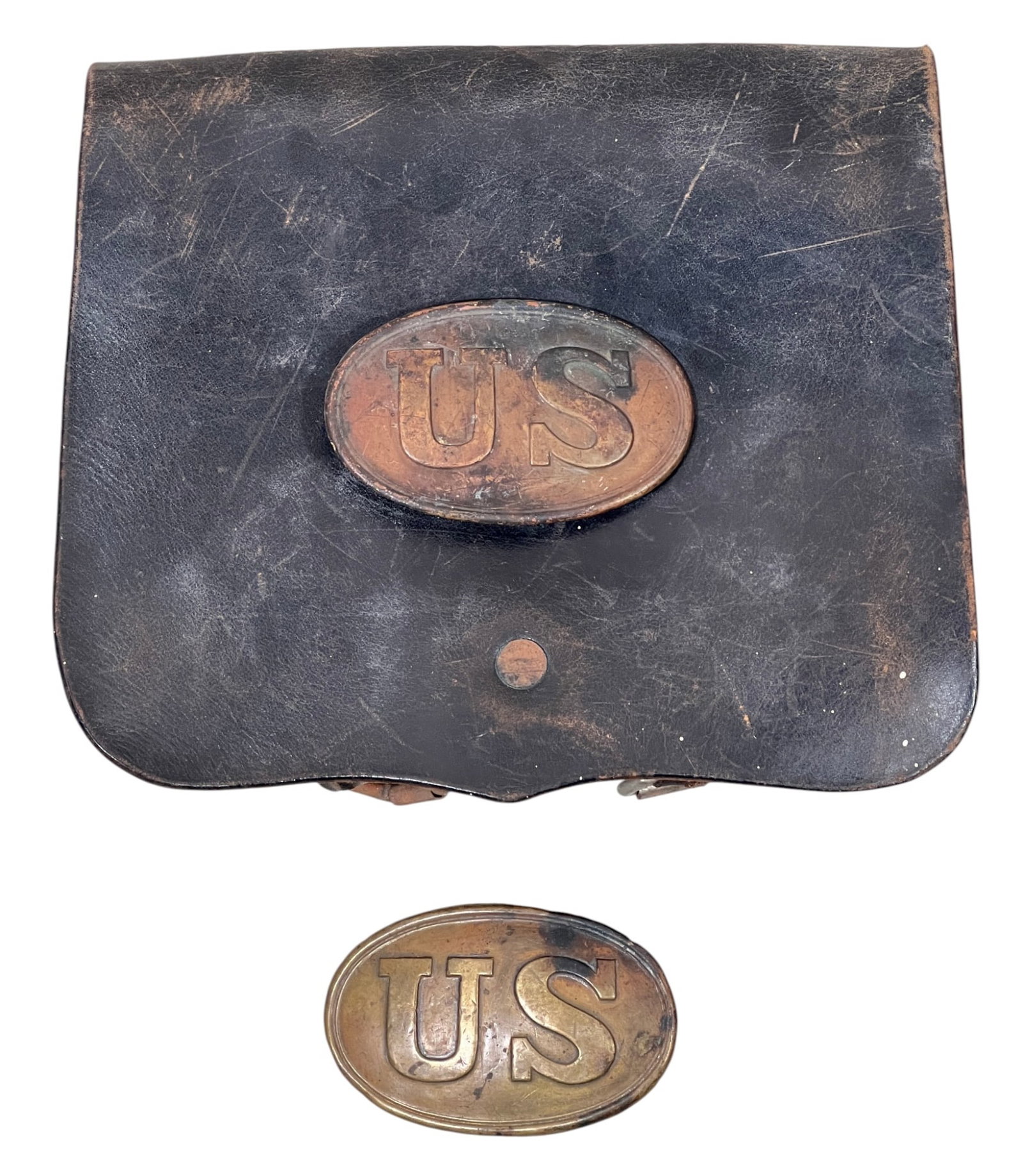 US CIVIL WAR LEATHER CARTRIDGE BOX & BELT BUCKLE: U.S. Civil War M1855/61 .58 caliber cartridge box with brass "US" badge along with a brass "US" belt buckle. Back of buckle inscribed with soldiers name "Dennis Ba?". 7 x 8 inches.