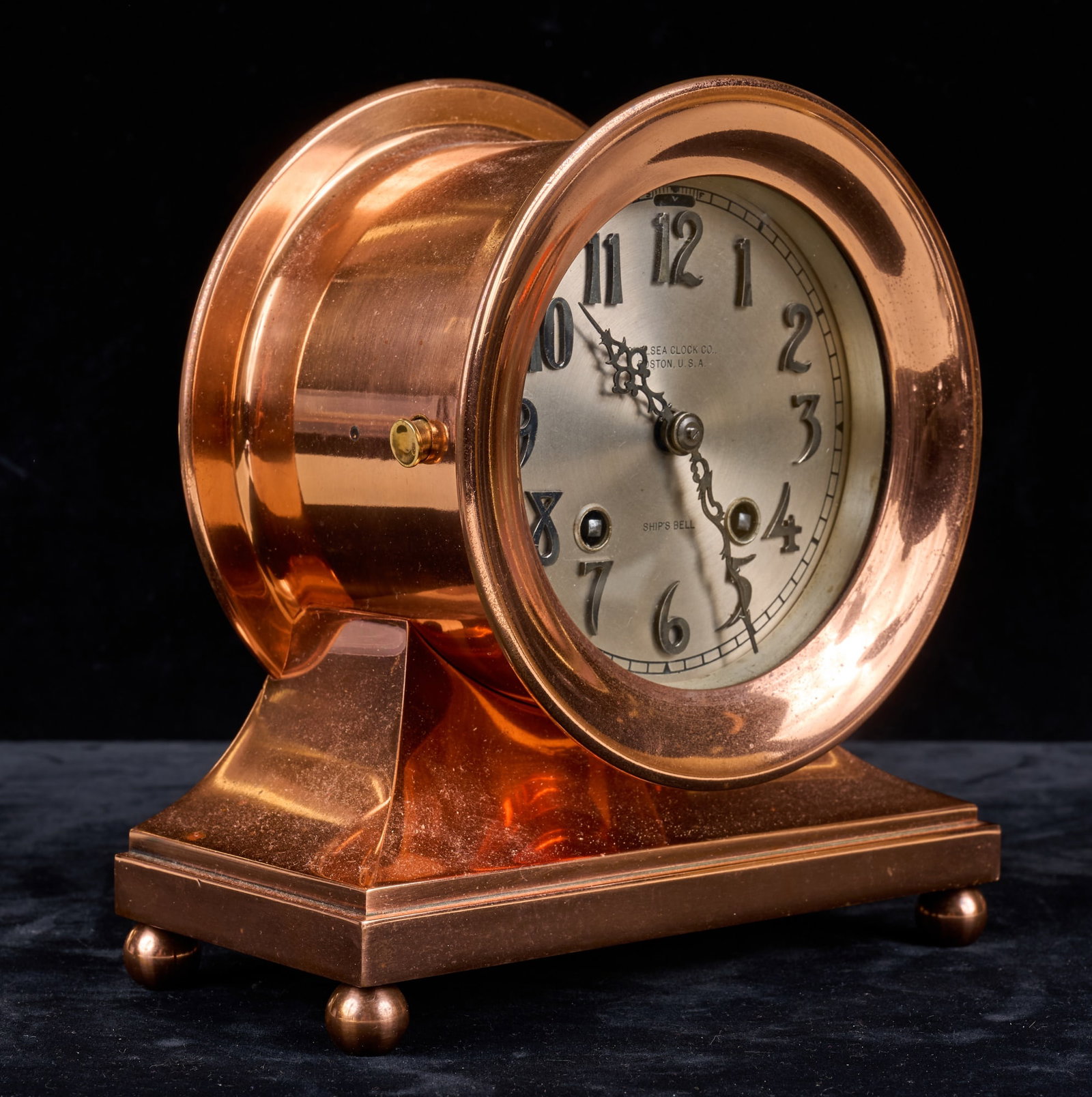 CHELSEA COPPER SHIPS BELL CLOCK: 5 1/2 inch copper finished case on continuous base, 3 3/4 inch silver dial with raised numerals & fancy hands, ships bell chime. 182732 stamped under base. 7 1/4 x 6 3/4 x 3 1/4 inches.