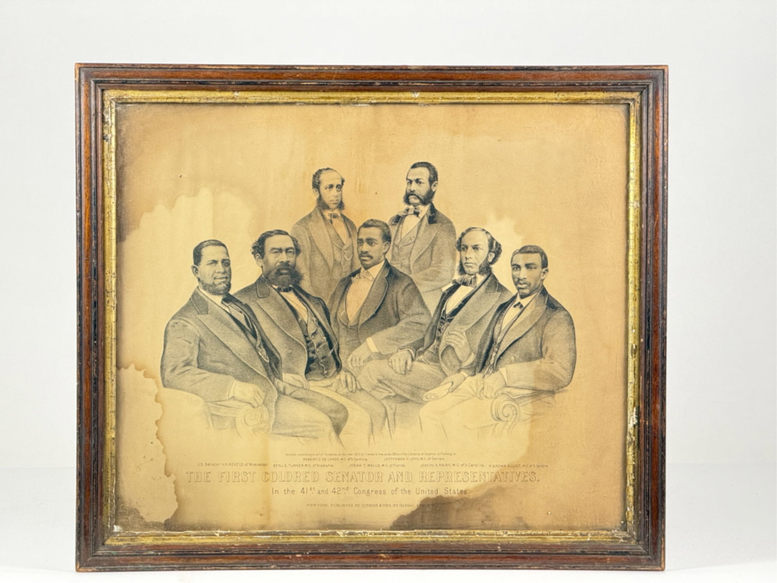 THE FIRST COLORED SENATOR & REPRESENTATIVES: 1872 Currier and Ives Lithograph showing Senator Hiram Revels and Representatives Benjamin Turner, Robert DeLarge, Josiah Walls, Jefferson Long, Joseph Rainey, and Robert Elliott. Housed in period fra