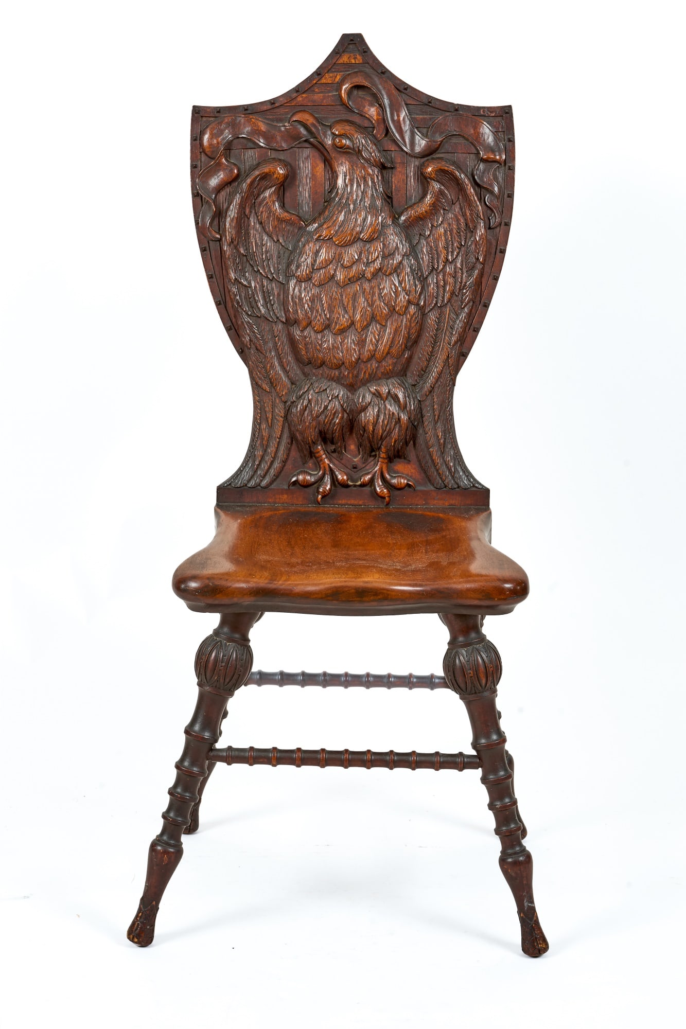 1876 BOSTON CENTENNIAL CARVED MAHOGANY SIDE CHAIR: Shield-back carved with the American Eagle clutching a banner over a ground of stripes and outlined with decorative carved wooden hob nails. The legs are boldly spool and bamboo turned. 41 x 16 1/2 x 