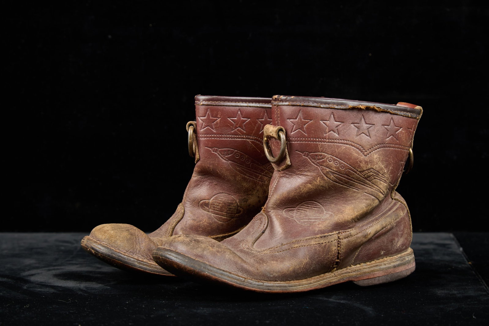 CHILDS BUCK ROGERS ERA LEATHER BOOTS: Vintage childs leather boots tooled with stars, spaceships, and planets. 5 x 7 1/2 x 2 1/2 inches.
