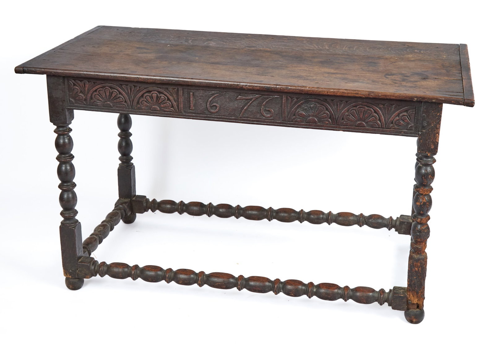 DATED 1676 WILLIAM & MARY CARVED OAK TAVERN TABLE: Bobbin turned legs & stretchers, apron carved with floral lunettes and dated 1676, pegged construction. 29 1/2 x 52 x 26 1/4 inches.