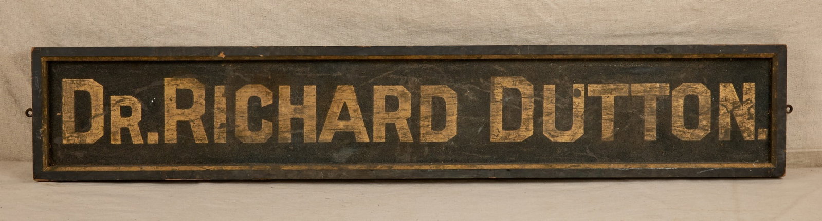 DR. RICHARD DUTTON ANTIQUE PAINTED WOODEN SIGN: With original black paint & gilt lettering. Dr. Richard Dutton believed to be of Wakefield, MA (1875-1950). 7 3/4 x 42 3/4 x 1 1/2 inches.