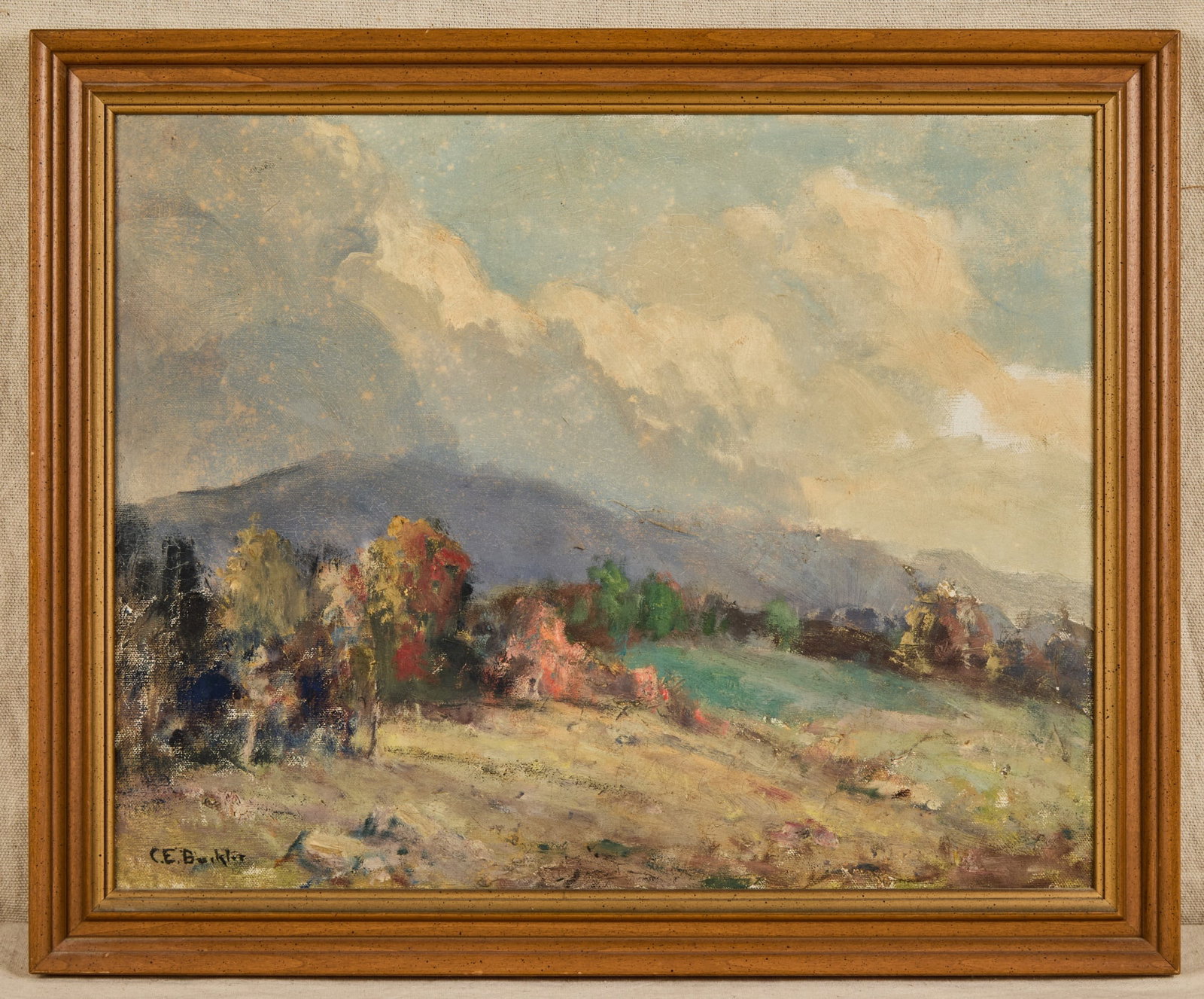 CHARLES BUCKLER (1869-1953): Hills in Autumn with Cap Clouds. oil on canvas 14 x 18 inches. signed. framed 17 x 20 1/2 inches (overall). Provenance: By direct lineal descent from the artist to his great granddaughter (the