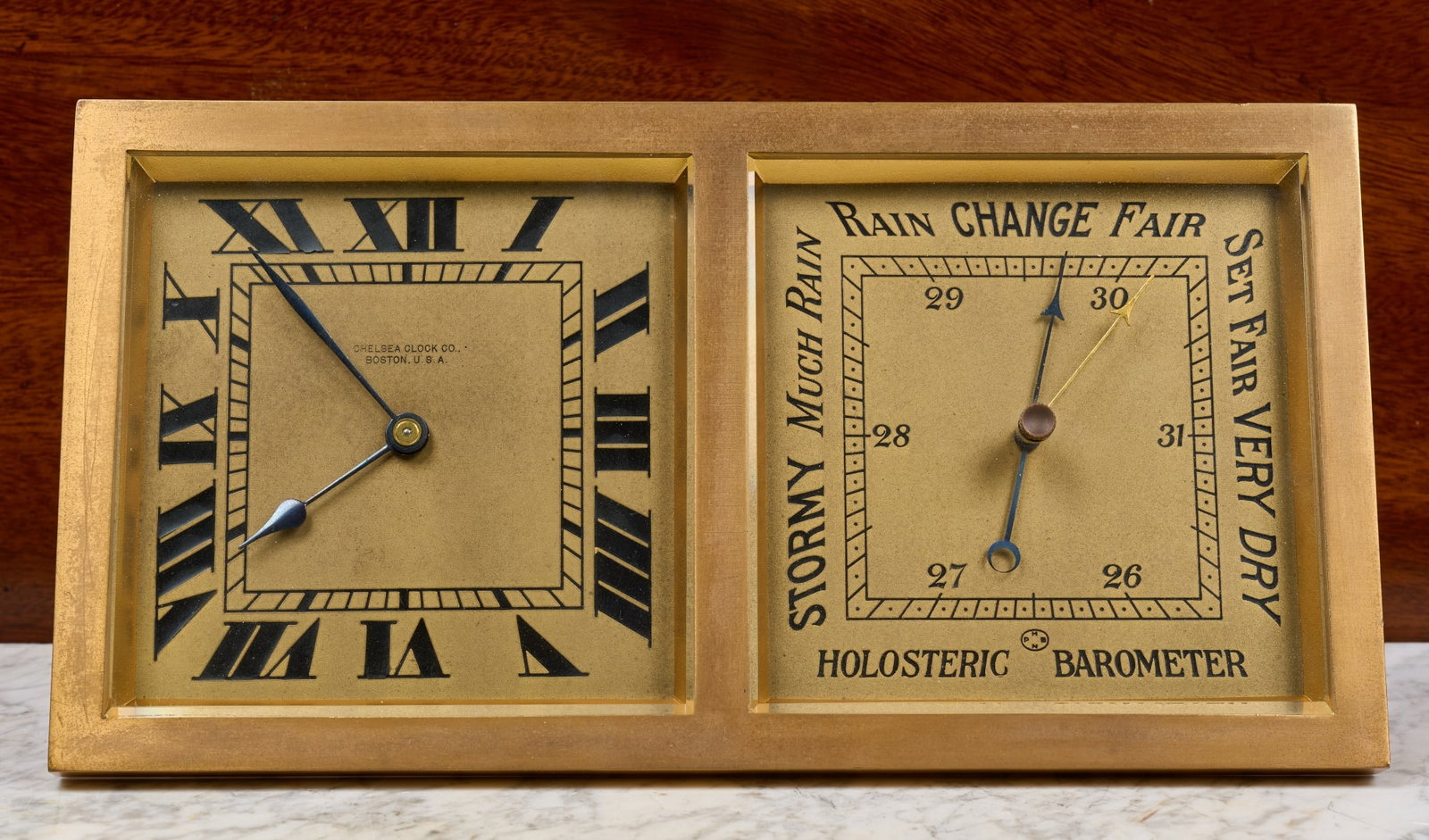 ART DECO CHELSEA CLOCK CO. DESK CLOCK BAROMETER: Brass case with beveled glass, engraved brass faces with Art Deco script. Serial no. 180902. 5 3/4 x 11 1/2 x 3 inches.