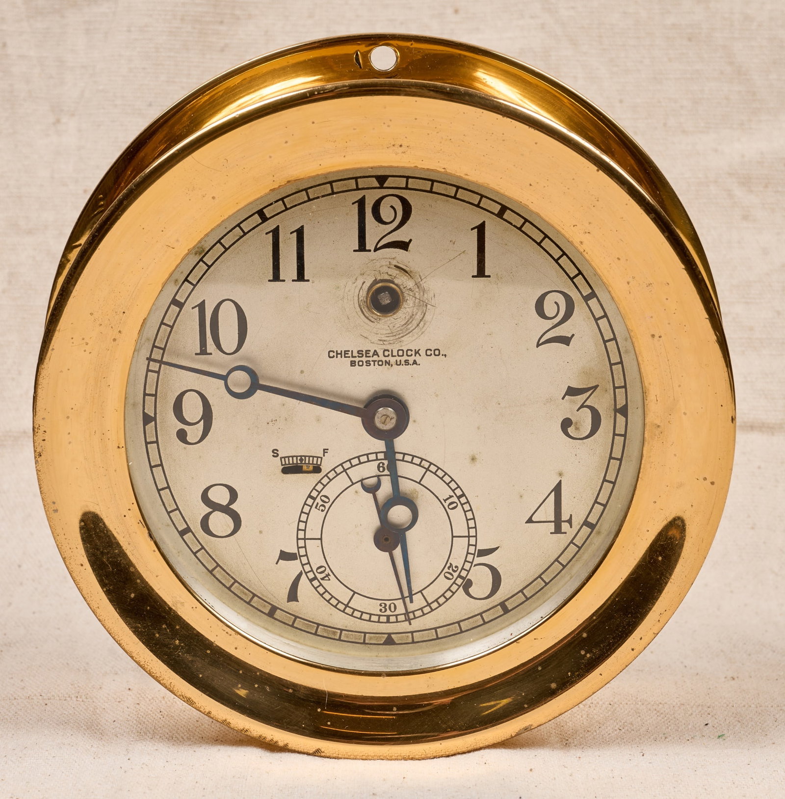 7 1/4 INCH CHELSEA CLOCK CO. BRASS CLOCK: 7 1/4 inch brass case, 5 1/2 inch engraved silver dial with Breguet hands. Serial no. 101376. 7 1/4 x 2 3/4 inches.