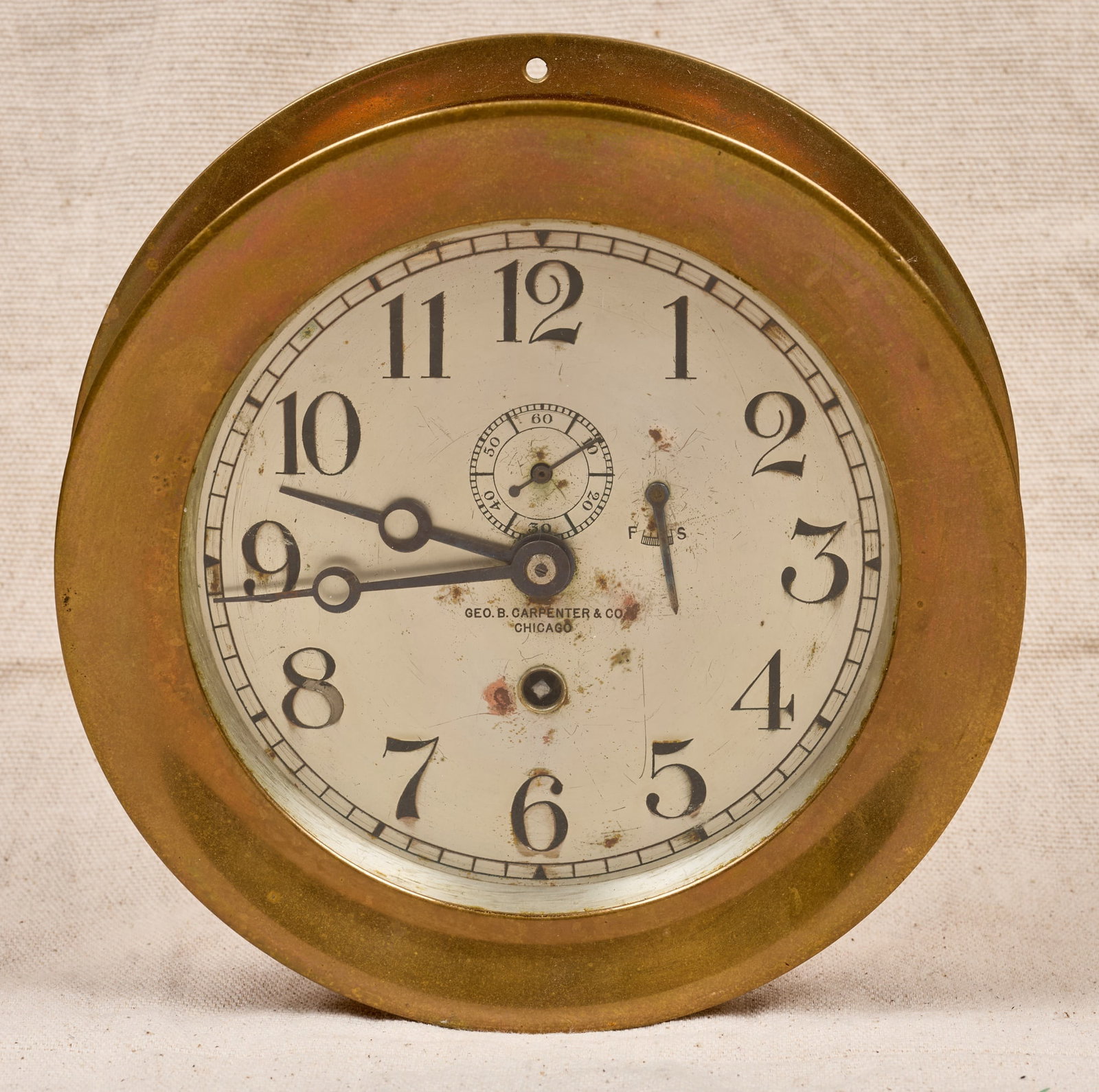 GEO. B CARPENTER & CO CHELSEA CLOCK: 7 1/4 inch brass case, 5 1/4 inch engraved silver dial with Geo. B. Carpenter & Co. (Chicago) retailers mark and Breguet hands. Serial no. 67921, circa 1910-14. 7 1/4 x 2 1/4 inches.
