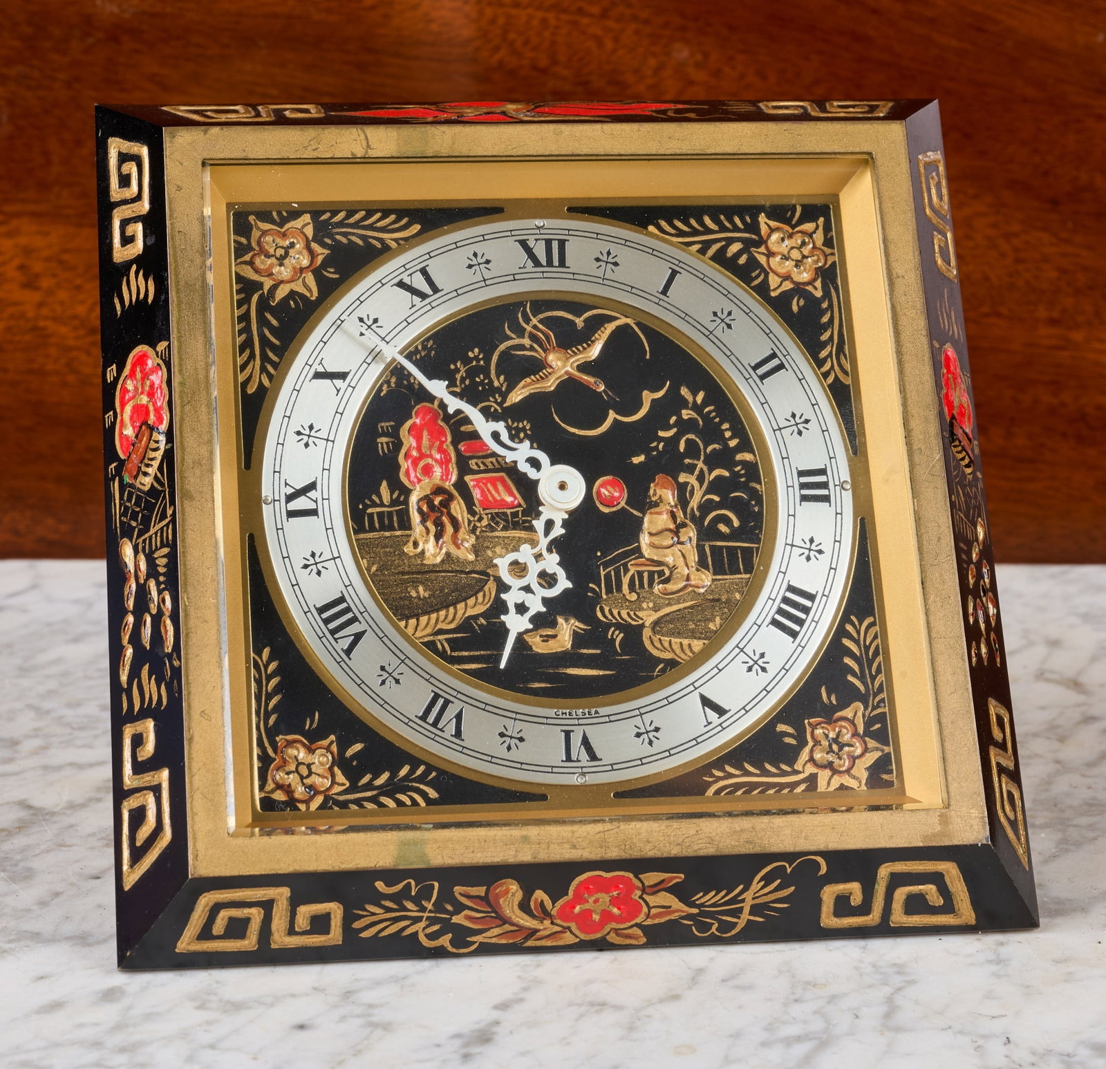 CHELSEA CLOCK CO. CHINOISERIE DESK CLOCK: 6 1/2 inch enameled beveled bronze case with beveled glass, 4 inch engraved silver dial on a hand enameled background with Chinese landscape scene. Serial no. 831552. 5 3/4 x 6 1/2 x 5 inches.