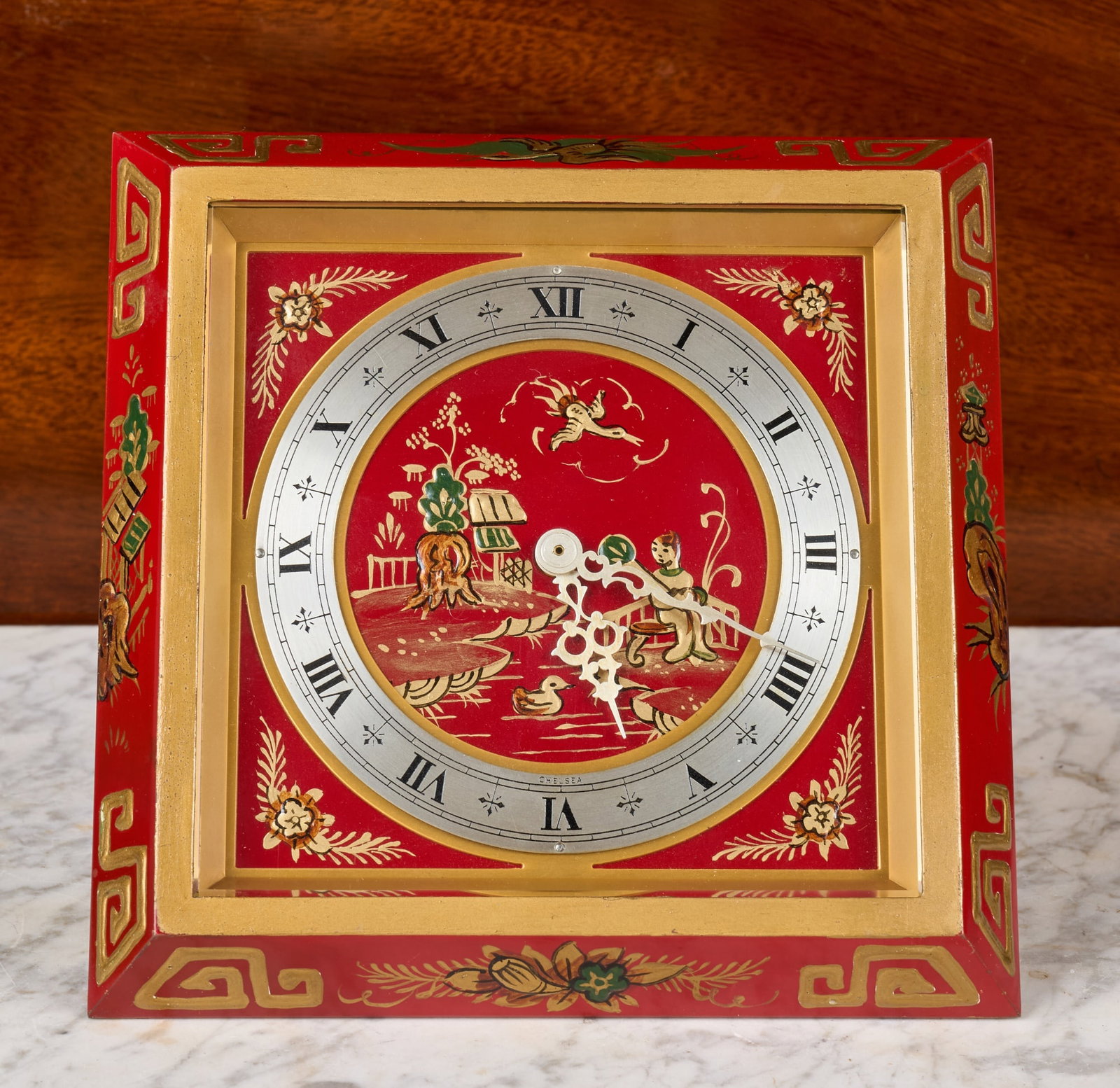 CHELSEA CLOCK CO. CHINOISERIE DESK CLOCK: 6 1/2 inch enameled beveled bronze case with beveled glass, 4 inch engraved silver dial on a hand enameled background with Chinese landscape scene. Serial no. EO712971. 5 3/4 x 6 1/2 x 5 inches.