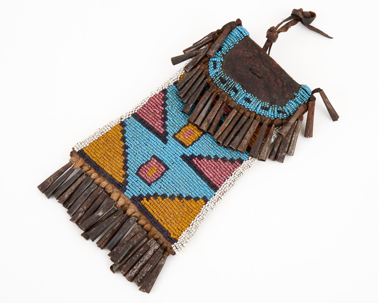 NATIVE AMERICAN BEADWORK STRIKE A LIGHT BAG: Horse hide leather with geometric polychrome beadwork & tin cone tassels. 7 1/4 x 4 1/4 inches.