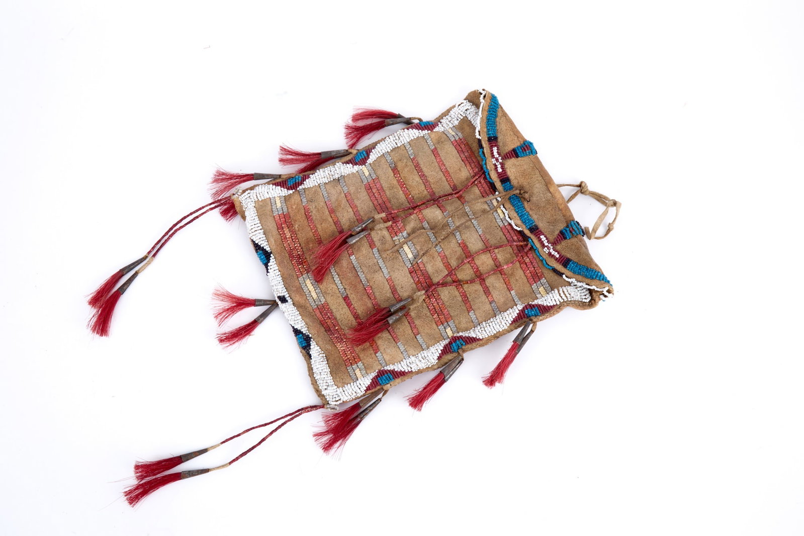 PLAINS INDIANS PARFLECHE BAG with QUILL & BEADWORK: Plains Indians rawhide parfleche bag with geometric polychrome bead & quill work, quill wrapped tin cone tassels with dyed horse hair. 9 1/4 x 7 1/2 inches.