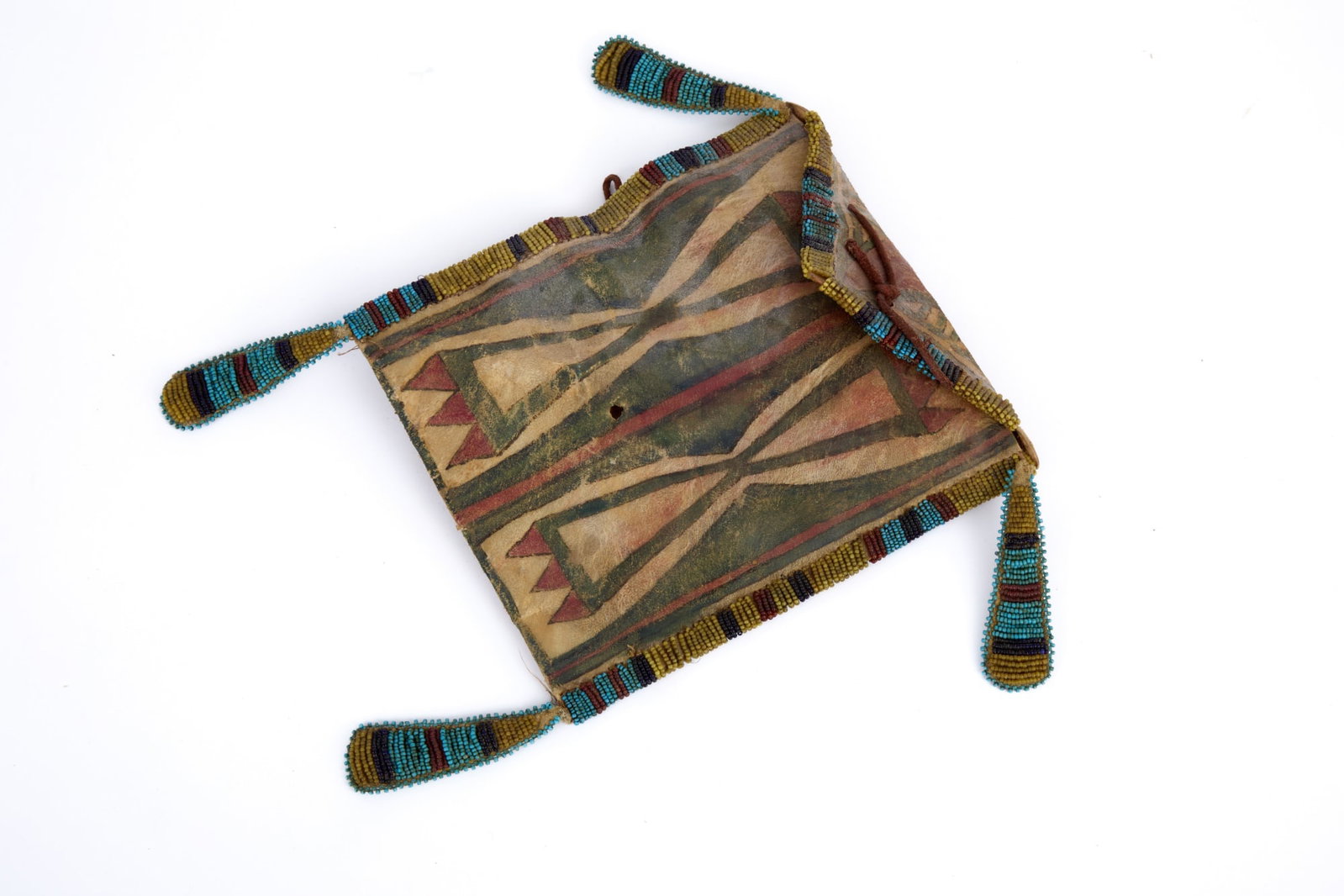 NATIVE AMERICAN PAINTED PARFLECHE BAG w BEADWORK: Native American rawhide parfleche bag with geometric polychrome paint decoration & polychrome beadwork border & tags. 8 x 7 inches.
