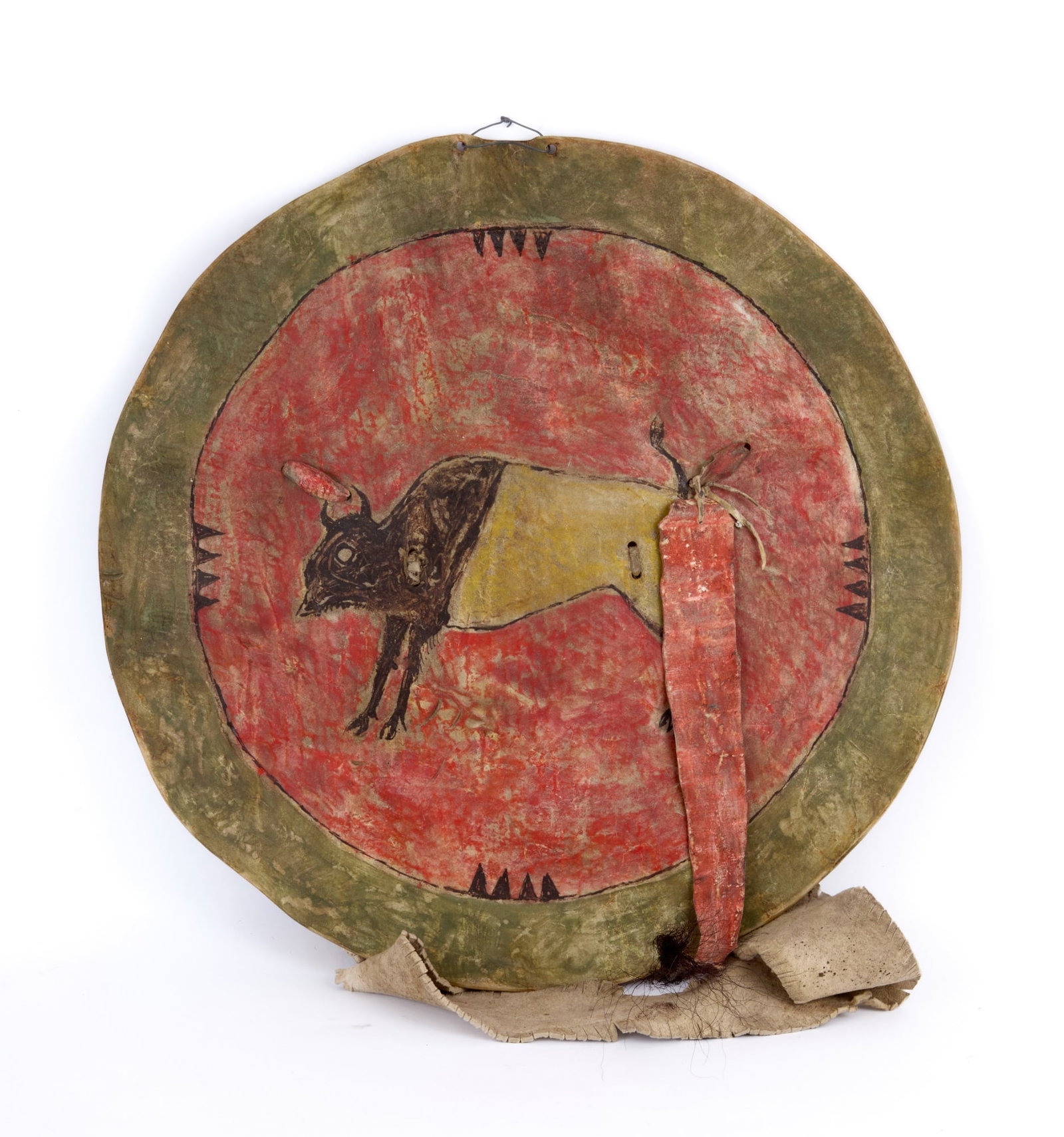 PLAINS INDIANS PAINTED RAWHIDE BISON SHIELD: Plains Indians rawhide shield painted with a bison on red ground with green border & bear claw marks.