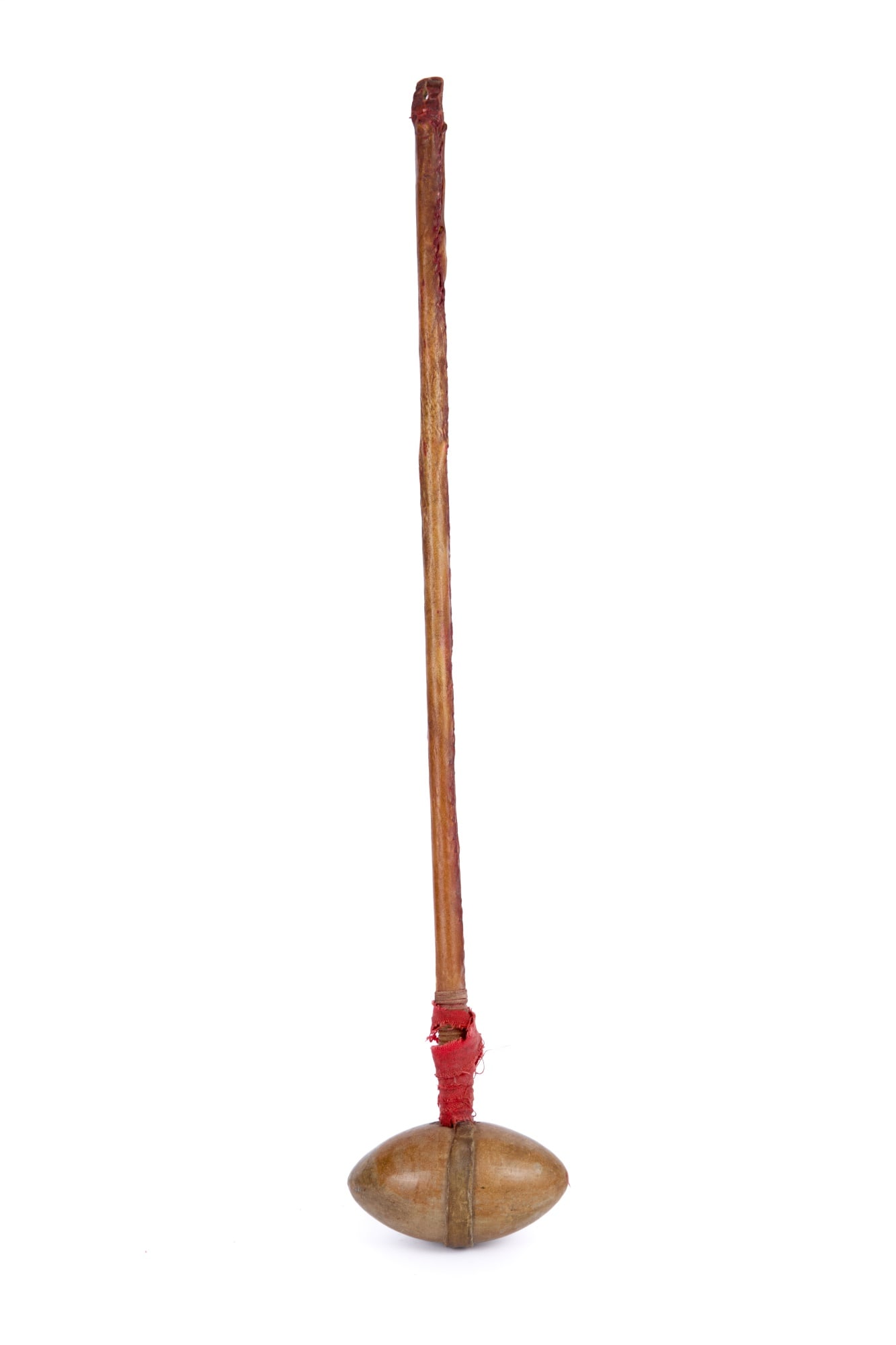 PLAINS INDIANS STONE HEAD WAR CLUB: Shaped stone head affixed to a rawhide wrapped wooden handle with red trade cloth wrap, red paint remnants. 24 1/2 inches.
