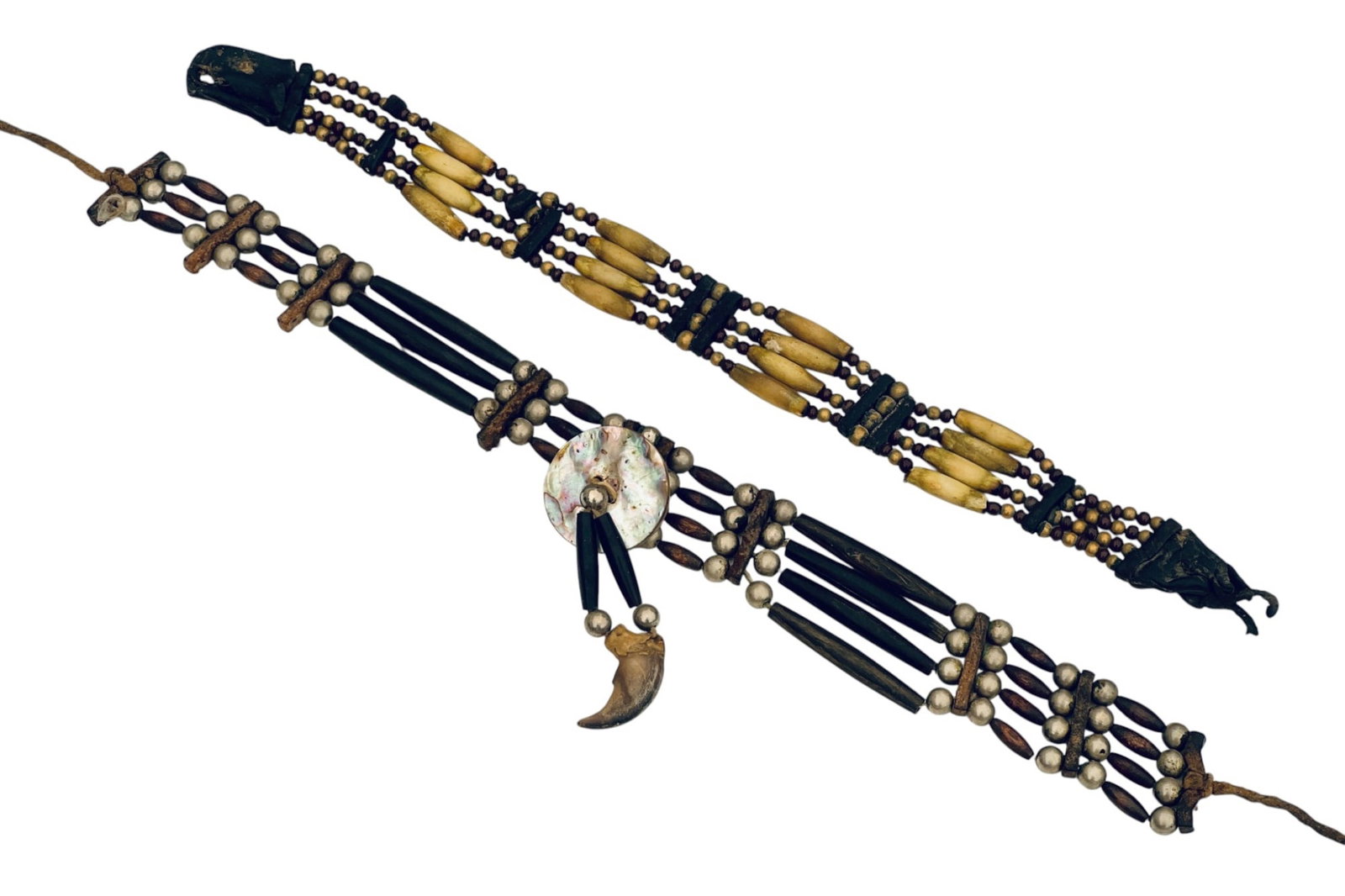 (2) ANTIQUE NATIVE AMERICAN BISON BONE CHOKERS: (2) antique Native American four row chokers made from bison bone, glass, metal, and wooden beads, and leather spacers. (1) with abalone & bear claw decoration. 14 1/4 inches.
