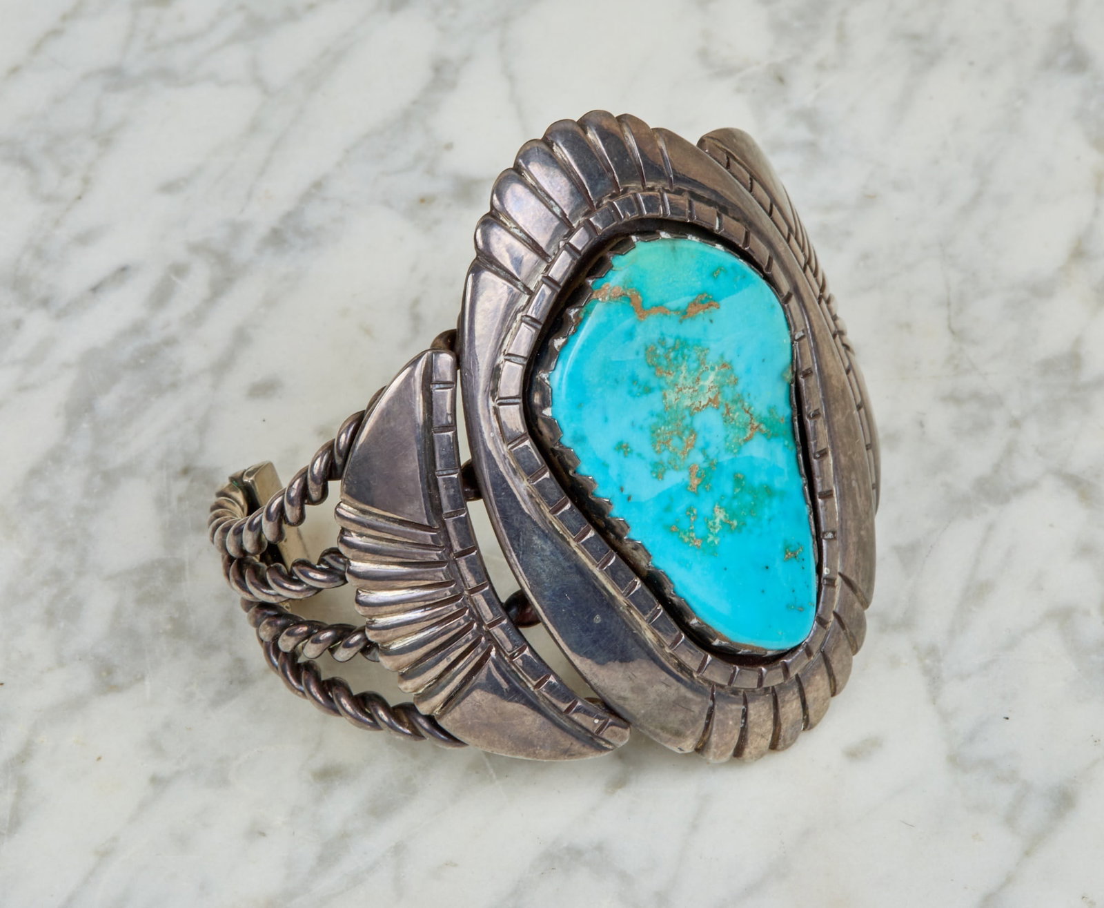 VINTAGE NATIVE AMERICAN BRACELET: Sterling silver and turquoise. 2 3/4 x 2 3/4 inches. 3.245 ozt gross weight.