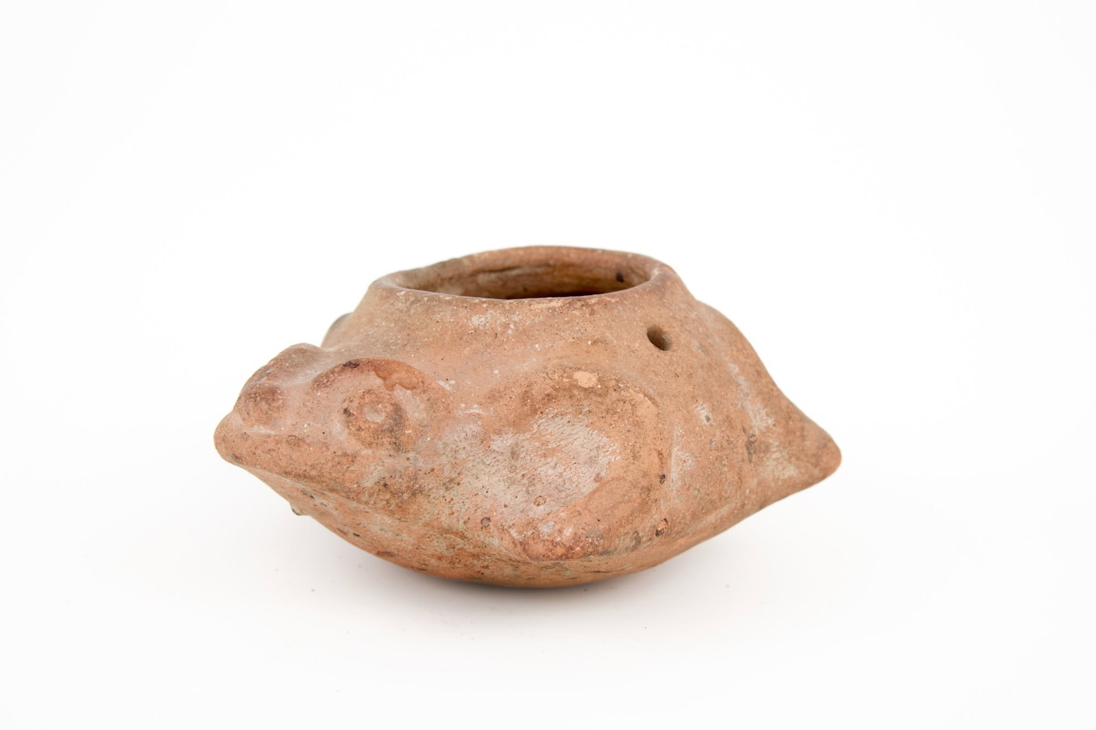 TERRA COTTA FROG EFFIGY BOWL/LAMP: Terra cotta frog effigy with holes on either side to suspend. 2 1/4 x 3 1/4 x 4 1/2 inches.