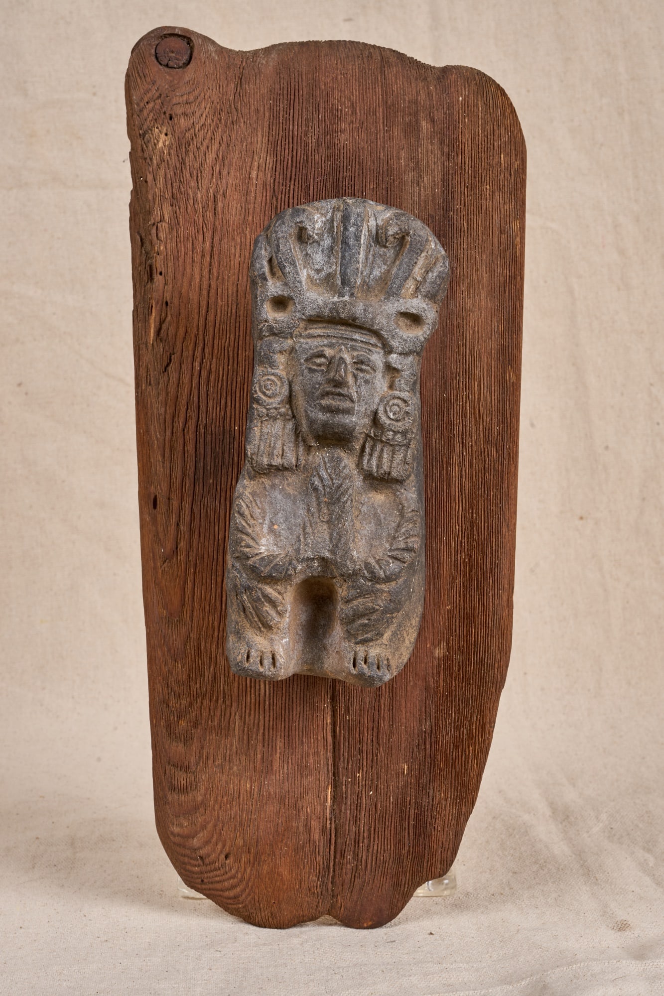 FIGURAL PRE-COLUMBIAN TERRACOTTA VESSEL: Figural Pre-Columbian terra cotta vessel depicting a seated deity, mounted to an old wooden board for use as a wall pocket. 7 1/2 inches excluding board; 15 x 6 1/2 inches overall.