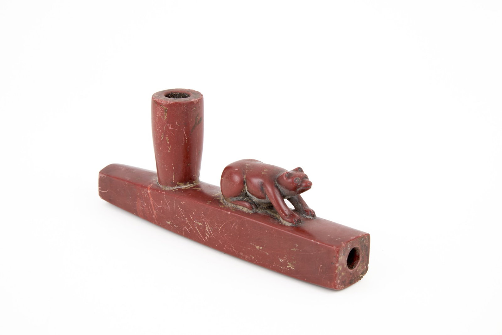 "CHIEF CROW KING" CARVED CATLINITE PEACE PIPE: Figural Native American carved catlinite peace pipe with bear, inscribed under base "Lakota peace pipe Fort Laramie 1867? Chief Crow King". 3 x 7 inches. N.B. Chief Crow King was a general/warrior und