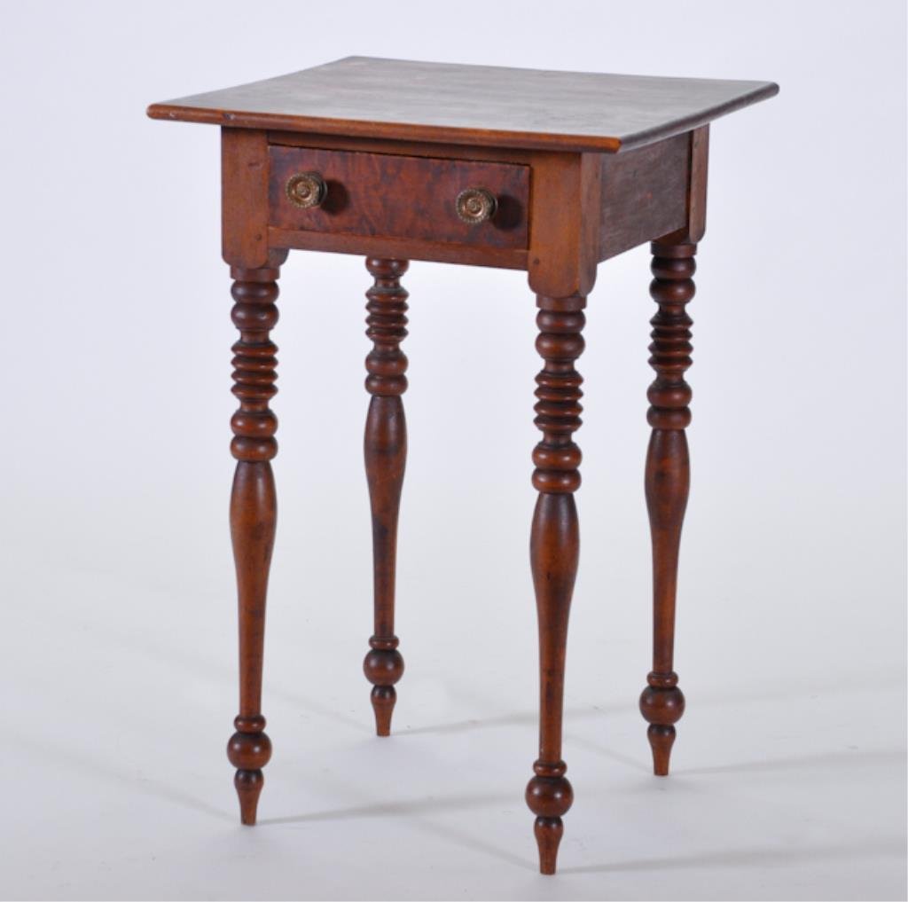 (19th c.) One-Drawer Stand: Sheraton stand of pine and maple on spool-turned legs. 27 5/8 x 17 1/2 x 18 inches. Condition: Surface wear. Pulls are replaced.