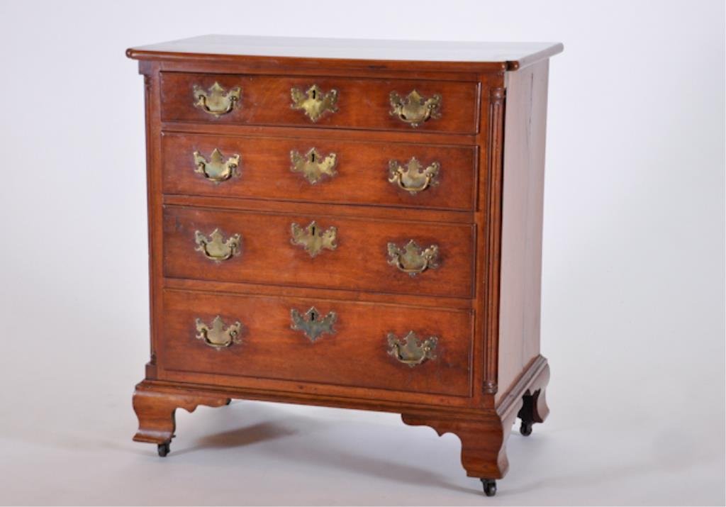 (Late 18th c.) Cherry Bachelor's Chest: Notched rectangular top above four graduated drawers with brass pulls, matching escutcheons and filleted quarter columns. Curved bracket feet with later casters. 35 1/4 x 31 x 19 3/4 inches. Condition